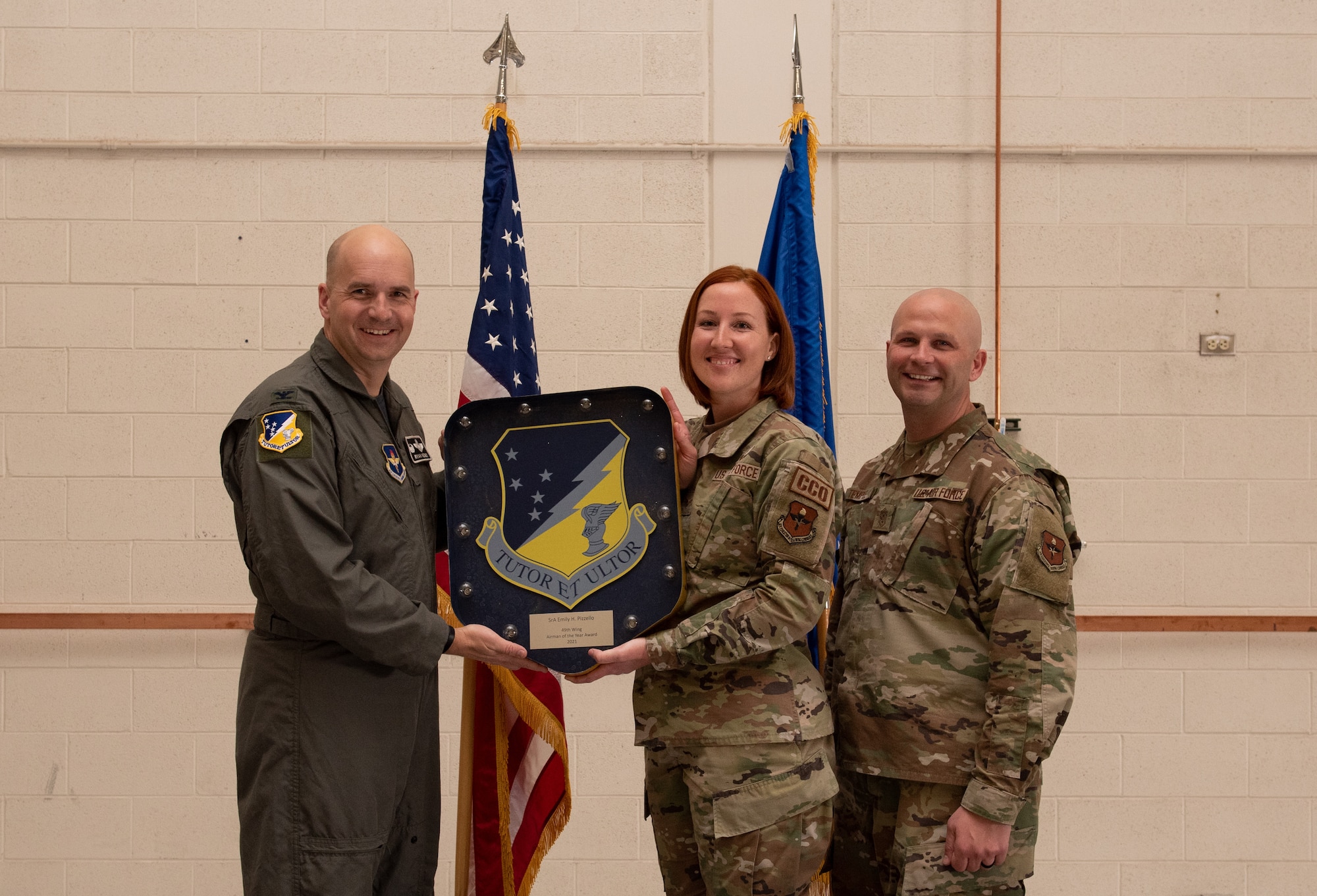 Senior Airman Emily Pizzello, 49th Contracting Squadron annual award winner, accepts the 49th Wing Airman of the Year award during the 49th Wing annual awards ceremony, March 4, 2022, on Holloman Air Force Base, New Mexico. Annual award winners were selected based on their technical expertise, demonstration of leadership and job performance. (U.S. Air Force photo by Airman 1st Class Nicholas Paczkowski)