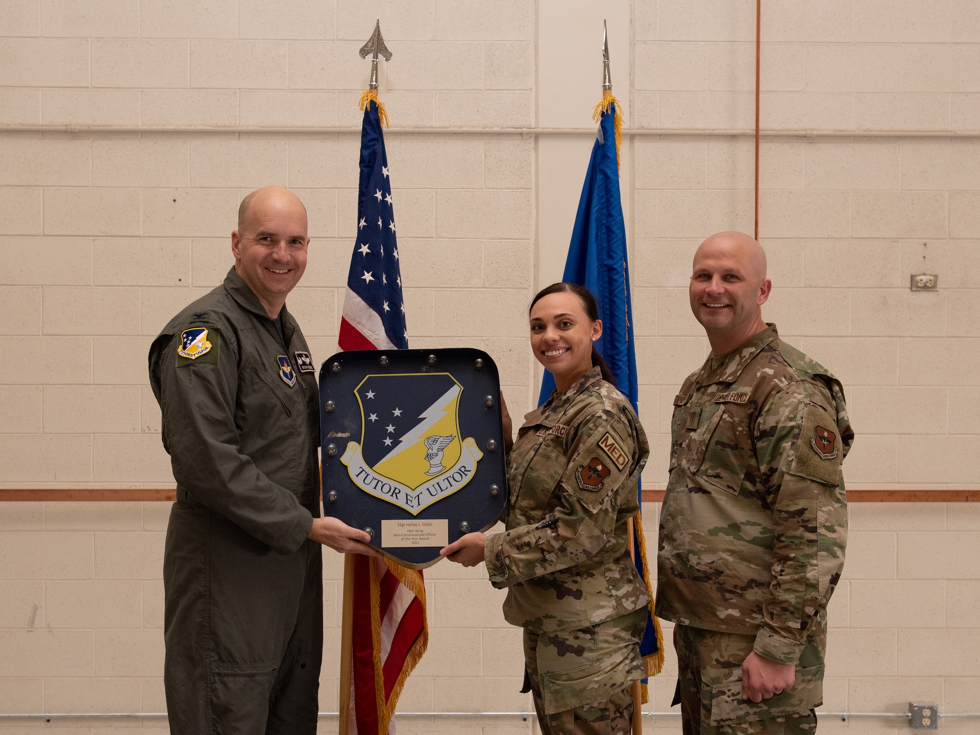 Staff Sgt. Hailey Gibbs, 49th Medical Group annual award winner, accepts the 49th Wing Noncommissioned Officer of the year award during the 49th Wing annual awards ceremony, March 4, 2022, on Holloman Air Force Base, New Mexico. Annual award winners were selected based on their technical expertise, demonstration of leadership and job performance. (U.S. Air Force photo by Airman 1st Class Nicholas Paczkowski)