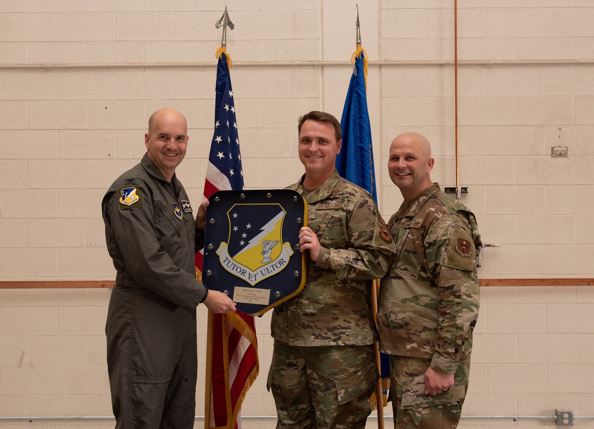 Master Sgt. Louis Cotter, 54th Fighter Group annual award winner, accepts the 49th Wing Senior Noncommissioned Officer of the year award during the 49th Wing annual awards ceremony, March 4, 2022, on Holloman Air Force Base, New Mexico. Annual award winners were selected based on their technical expertise, demonstration of leadership and job performance. (U.S. Air Force photo by Airman 1st Class Nicholas Paczkowski)