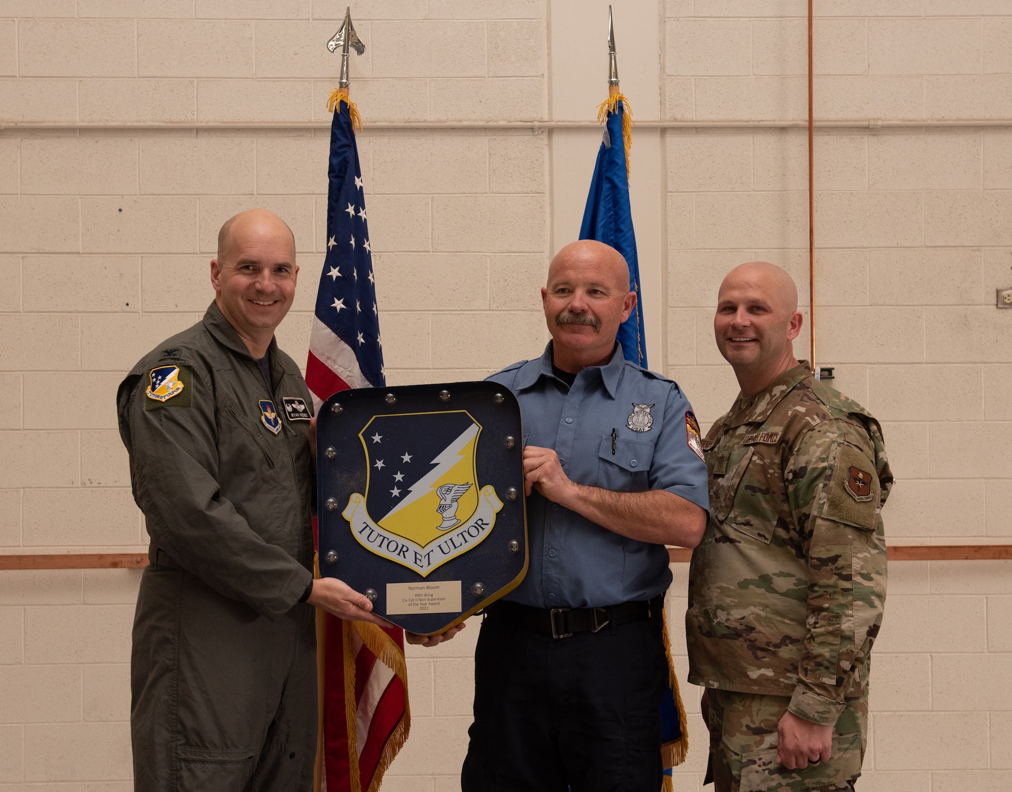 Norman Bloom, 49th Mission Support Group annual award winner, accepts the 49th Wing Civilian Category II (Non Supervisory) of the year award during the 49th Wing annual awards ceremony, March 4, 2022, on Holloman Air Force Base, New Mexico. Annual award winners were selected based on their technical expertise, demonstration of leadership and job performance. (U.S. Air Force photo by Airman 1st Class Nicholas Paczkowski)