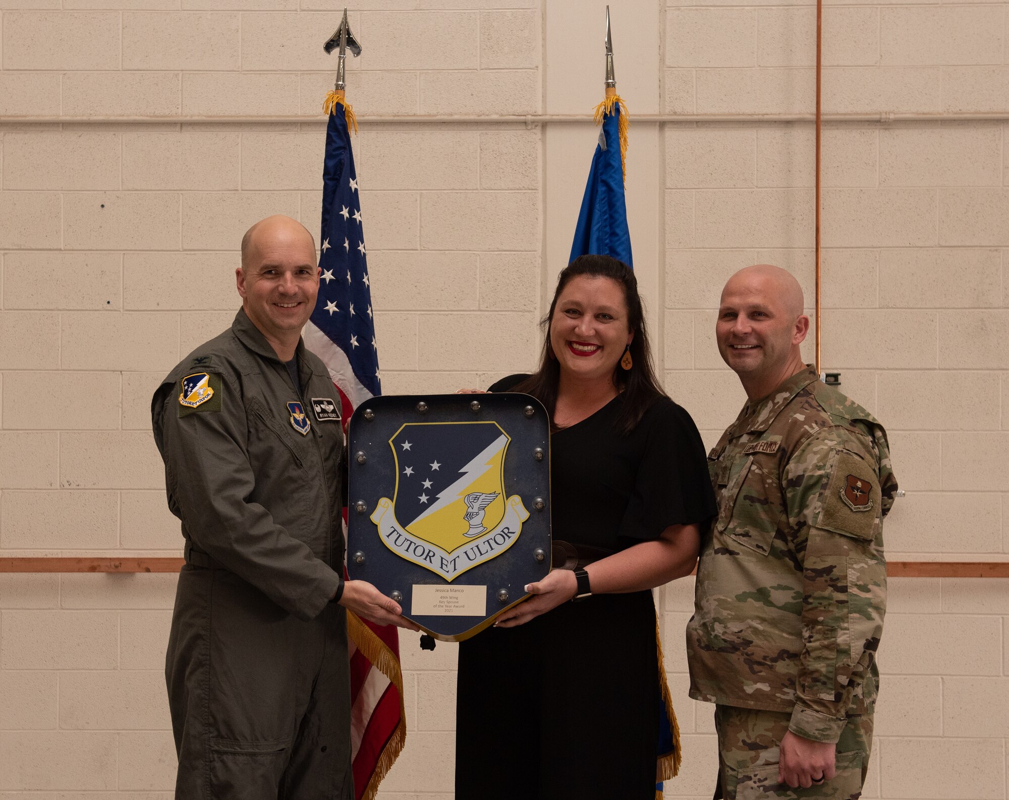 Jessica Manco, annual award winner, accepts the Key Spouse of the year award during the 49th Wing annual awards ceremony, March 4, 2022, on Holloman Air Force Base, New Mexico. Annual award winners were selected based on their technical expertise, demonstration of leadership and job performance. (U.S. Air Force photo by Airman 1st Class Nicholas Paczkowski)