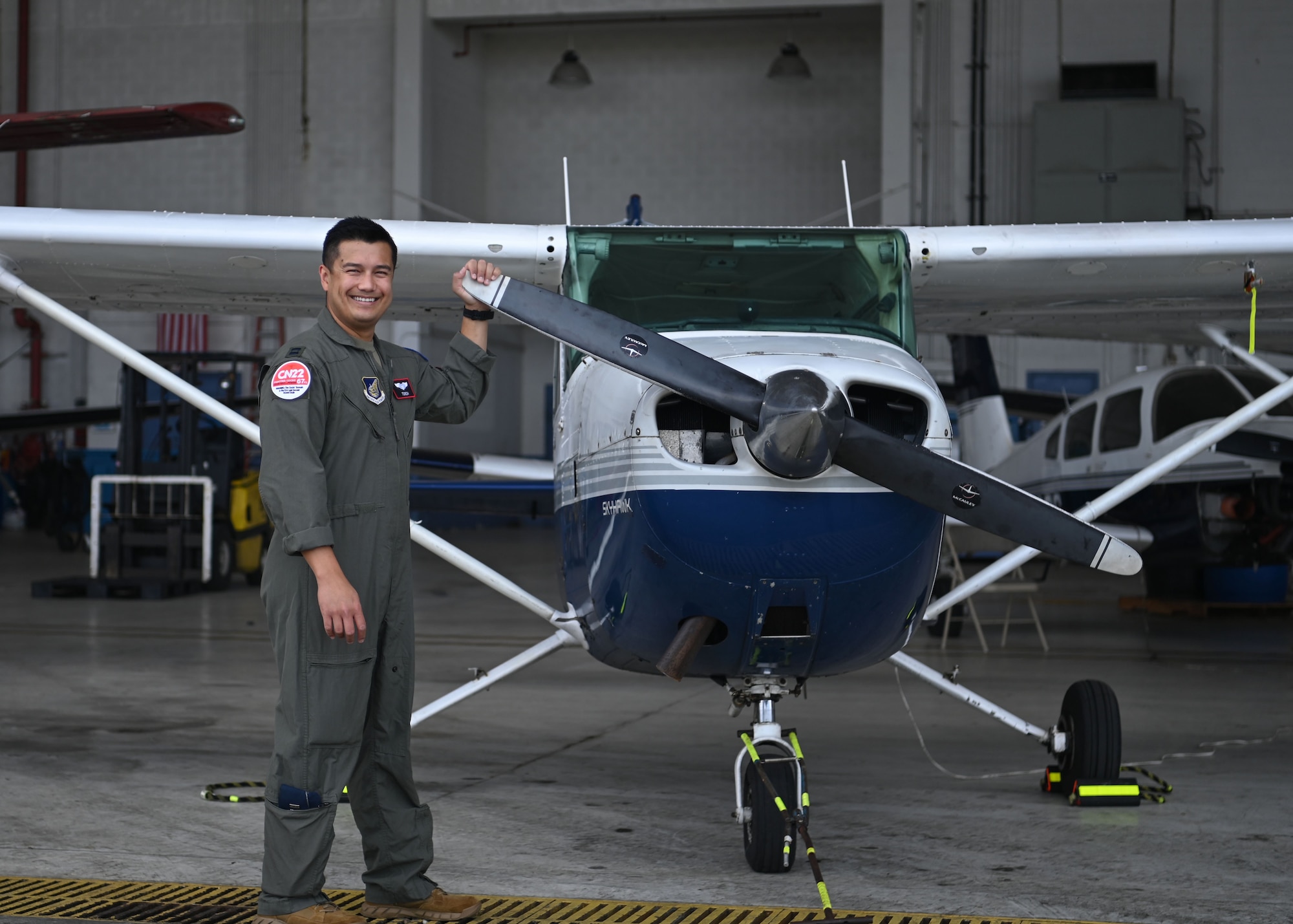 U.S. Air Force Capt. Celestino Aguon, also known as “Torch”, an F-15C Eagle pilot with the 67th Fighter Squadron assigned to Kadena Air Base, Japan, takes a photo next to the first aircraft he flew prior to joining the military at Antonio B. Won Pat International Airport, Guam, Feb. 23, 2022. Aguon returned to his home to participate in Exercise Cope North 2022, which is a multilateral U.S. Pacific Air Forces-sponsored field training exercise that is conducted annually at Andersen Air Force Base, Guam, that occurred from Feb. 2-18, 2022. (U.S. Air Force photo by Staff Sgt. Aubree Owens)