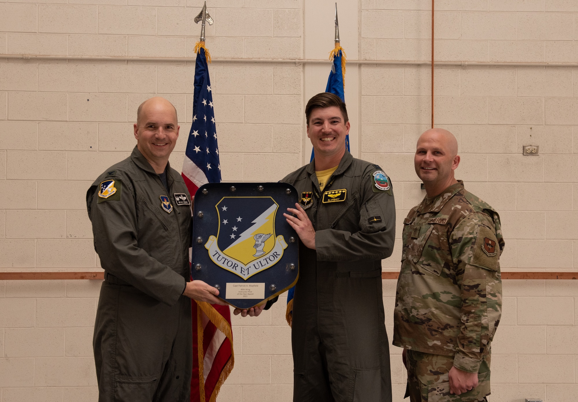Capt. Patrick Mayfield, 54th Fighter Group annual award winner, accepts the Instructor Pilot of the year award during the 49th Wing annual awards ceremony, March 4, 2022, on Holloman Air Force Base, New Mexico. Annual award winners were selected based on their technical expertise, demonstration of leadership and job performance. (U.S. Air Force photo by Airman 1st Class Nicholas Paczkowski)
