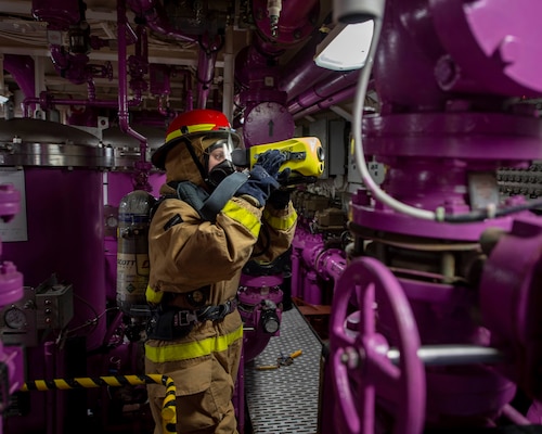 Machinist’s Mate 3rd Class Erin Deckard, assigned to the aircraft carrier USS George H.W. Bush, uses a Naval firefighting thermal imager at a general quarters drill during Tailored Ship’s Training Availability/Final Evaluation Problem (TSTA/FEP)