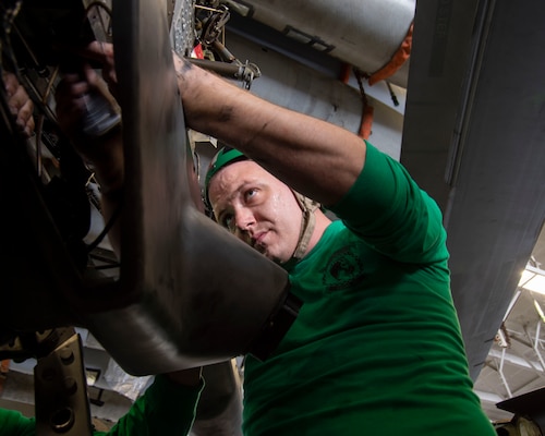 Aviation Structural Mechanic 3rd Class Cage Allen, assigned to Helicopter Maritime Strike Squadron (HSM) 46, does maintenance on an MH-60R Sea Hawk helicopter in the hangar bay of the aircraft carrier USS George H.W. Bush (CVN 77) during Tailored Ship's Training Availability/Final Evaluation Problem (TSTA/FEP