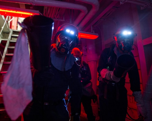 Sailors assigned to the aircraft carrier USS George H.W. Bush (CVN 77) practice firefighting techniques at a general quarters drill during Tailored Ship's Training Availability/Final Evaluation Problem (TSTA/FEP),