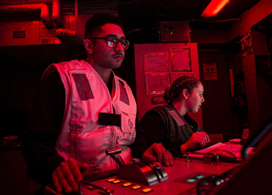 Aviation Machinist's Mate 1st Class Mark Salinas, left, and Airman Alexandra Mccoy operate the control panel of an F414 jet engine aboard the aircraft carrier USS George H. W. Bush (CVN 77) during Tailored Ship's Training Availability/Final Evaluation Problem (TSTA/FEP),