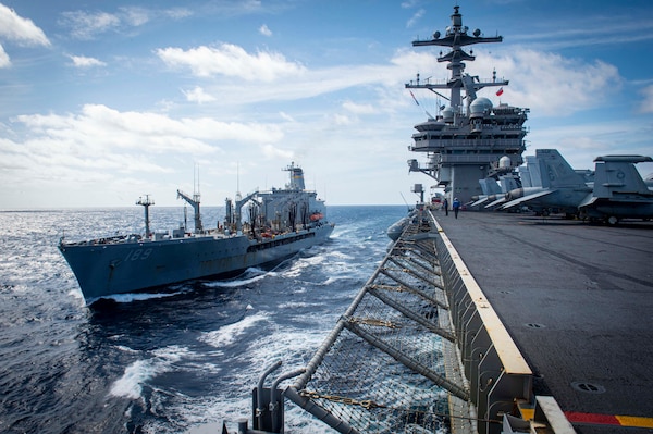 The replenishment oiler USNS John Lenthall (T-AO 189) transits along side the aircraft carrier USS George H.W. Bush (CVN 77) for a replenishment-at-sea during Tailored Ship's Training Availability/Final Evaluation Problem (TSTA/FEP)