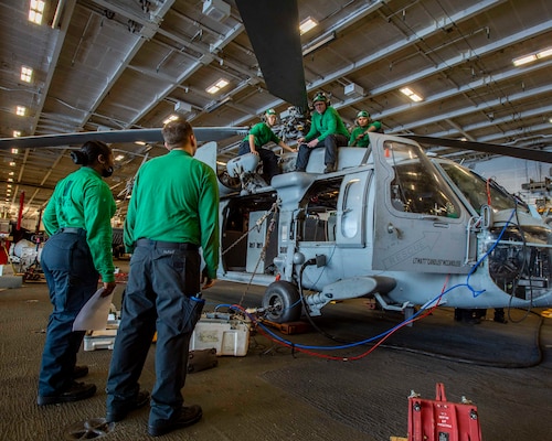 Sailors assigned to Helicopter Sea Combatant Squadron (HSC) 5, aboard the aircraft carrier USS George H.W. Bush, inspect equipment during Tailored Ship's Training Availability/Final Evaluation Problem (TSTA/FEP)