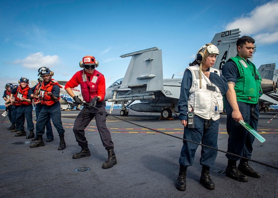 Sailors assigned to the aircraft carrier USS George H.W. Bush (CVN 77), heave a line attached to the replenishment oiler USNS John Lenthall (T-AO 189) during a replenishment-at-sea for Tailored Ship's Training Availability/Final Evaluation Problem (TSTA/FEP)