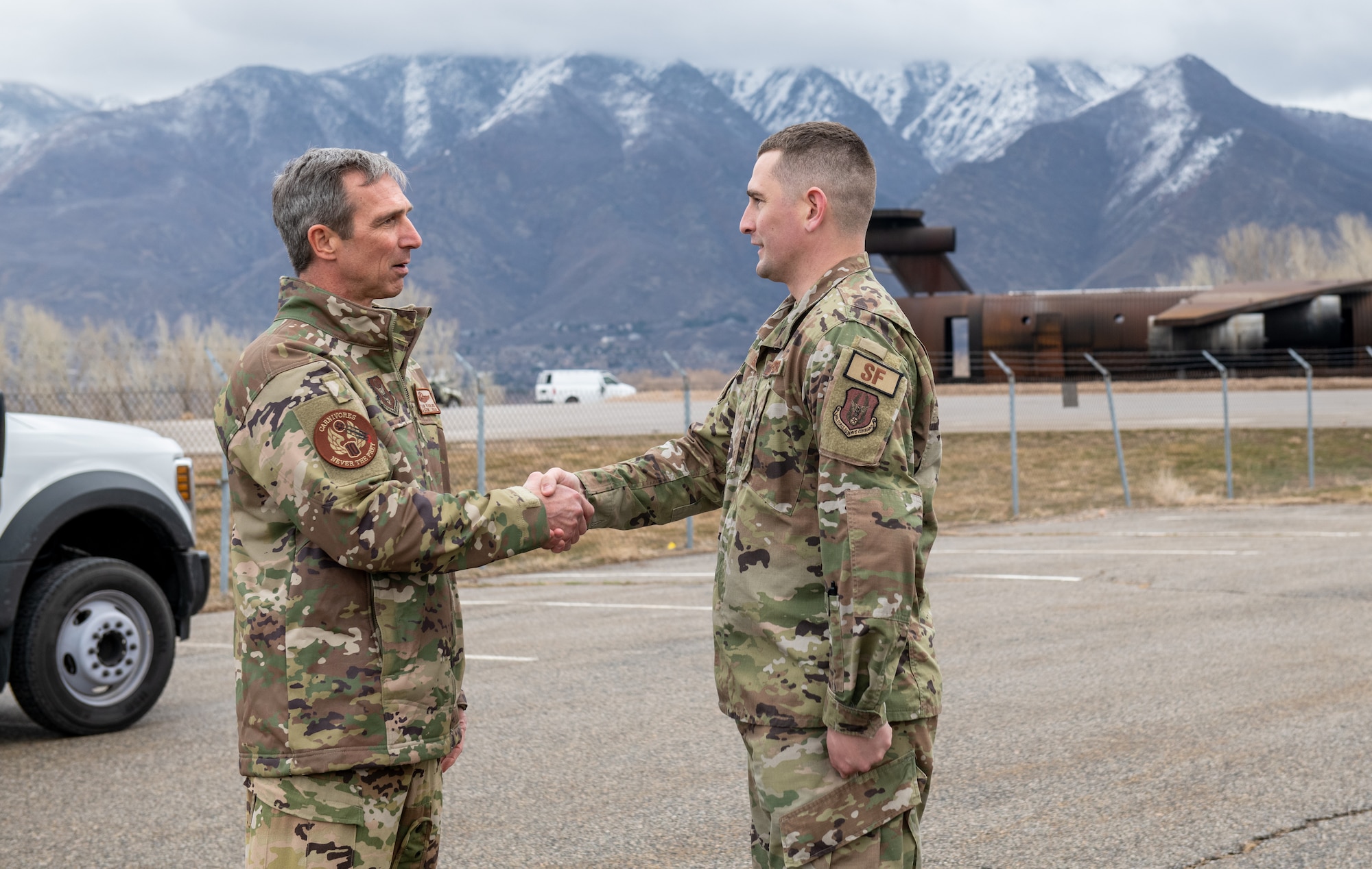 Maj. Gen. Bryan Radliff, 10th Air Force commander, presents a coin to Tech. Sgt. Robert Osmond, 419th Security Forces Squadron, during a tour of the 419th Fighter Wing