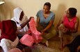 Two members of the Tedhilt Women’s Association show members of the Air Base 201 Women’s Associations their sewing projects in Agadez, Niger, March 6, 2022. Tedhilt Women’s Association offers a two-year program, which teaches women how to use a sewing machine and build a business to become financially secure. The AB201 Women’s Association supported the Tedhilt Women’s Association by purchasing approximately 250,000 West African CFA francs ($420 USD) of handmade scarfs, ceramic sculptures, received henna tattoos and commissioned four dresses. (U.S. Air Force photo by Tech. Sgt. Stephanie Longoria)