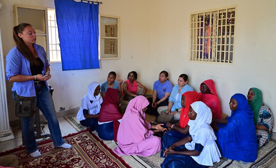 U.S. Army Spc. Mary Leszczuk, 404th Civil Affairs Battalion airborne specialist, explains women’s day to the members of the Air Base 201 Women’s Association and the members of Tedhilt Women’s Association in Agadez, Niger, March 6, 2022. The two associations celebrated International Women’s Day and discussed the social, economic, cultural, and political achievements of women. Events like this provide an opportunity to strengthen their relationship with one another and learn about each other’s day-to-day life. (U.S. Air Force photo by Tech. Sgt. Stephanie Longoria)