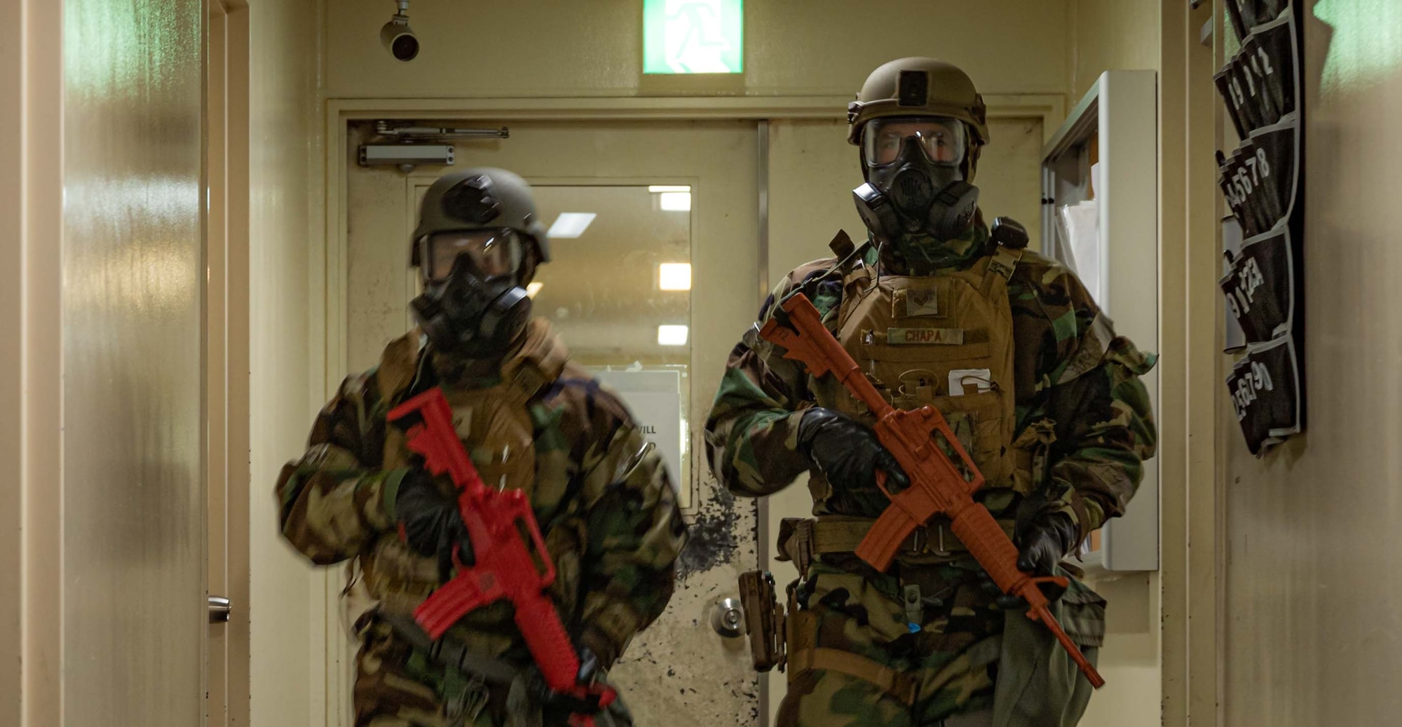 photo of Security Forces Airmen patrolling with a training weapon