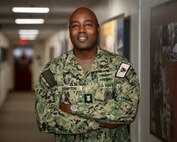 220306-N-KZ419-1001 MANAMA, Bahrain (March 6, 2022) Master Chief Lateef Compton, U.S. 5th Fleet's new command master chief, poses for a photo at U.S. Naval Forces Central Command headquarters, March 6.