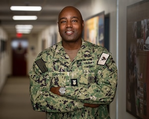 220306-N-KZ419-1001 MANAMA, Bahrain (March 6, 2022) Master Chief Lateef Compton, U.S. 5th Fleet's new command master chief, poses for a photo at U.S. Naval Forces Central Command headquarters, March 6.
