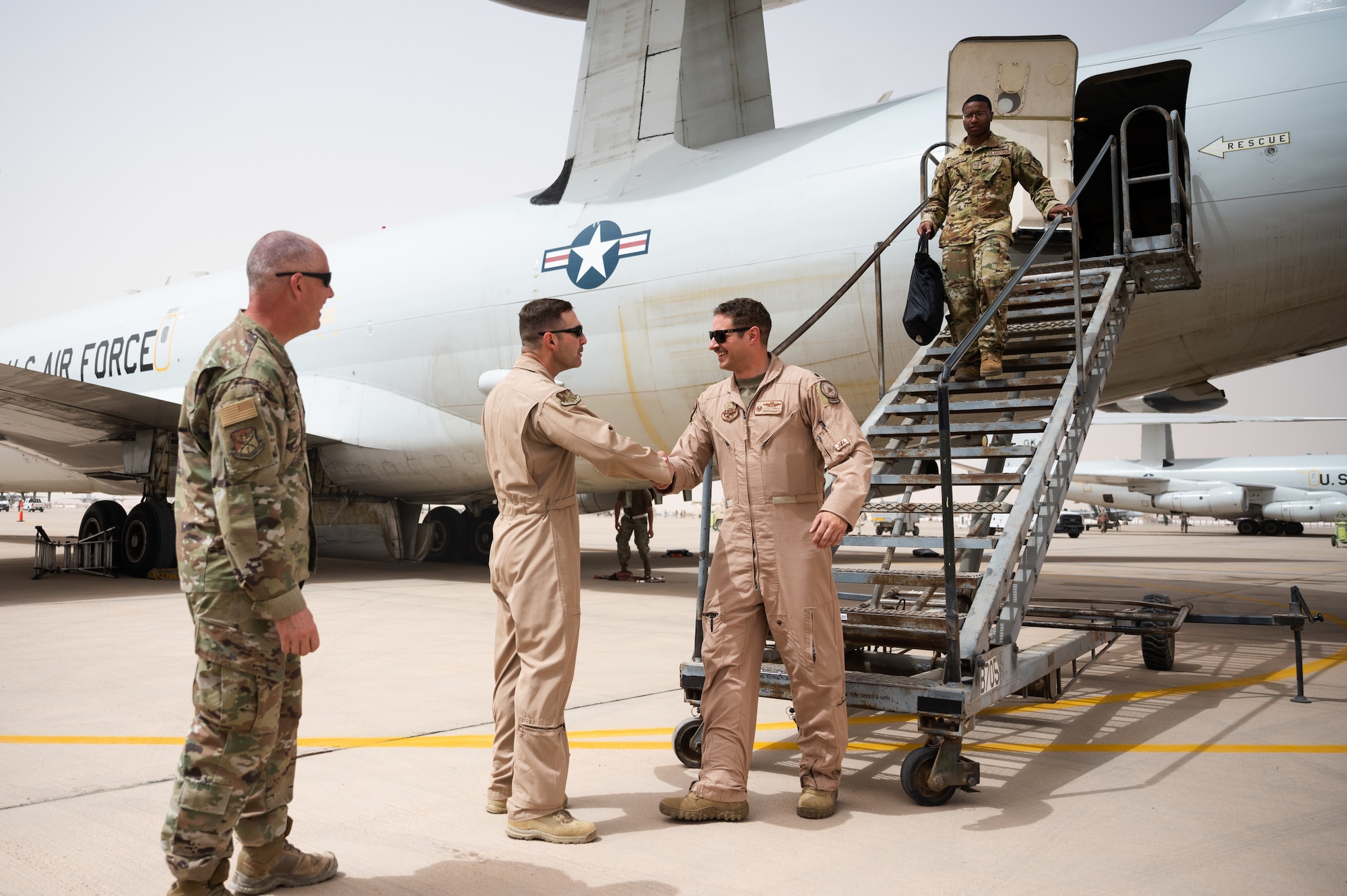 U.S. Air Force Brig. Gen. Robert Davis, 378th Air Expeditionary Wing commander, greets U.S. Air Force Lt. Col. Steven Bailey, 968th Expeditionary Airborne Air Control Squadron commander, at Prince Sultan Air Base, Kingdom of Saudi Arabia, March 6, 2022. Previously stationed at Al Dhafra Air Base, United Arab Emirates, the 968th EAACS will now begin operating from PSAB. (U.S. Air Force photo by Senior Airman Jacob B. Wrightsman)