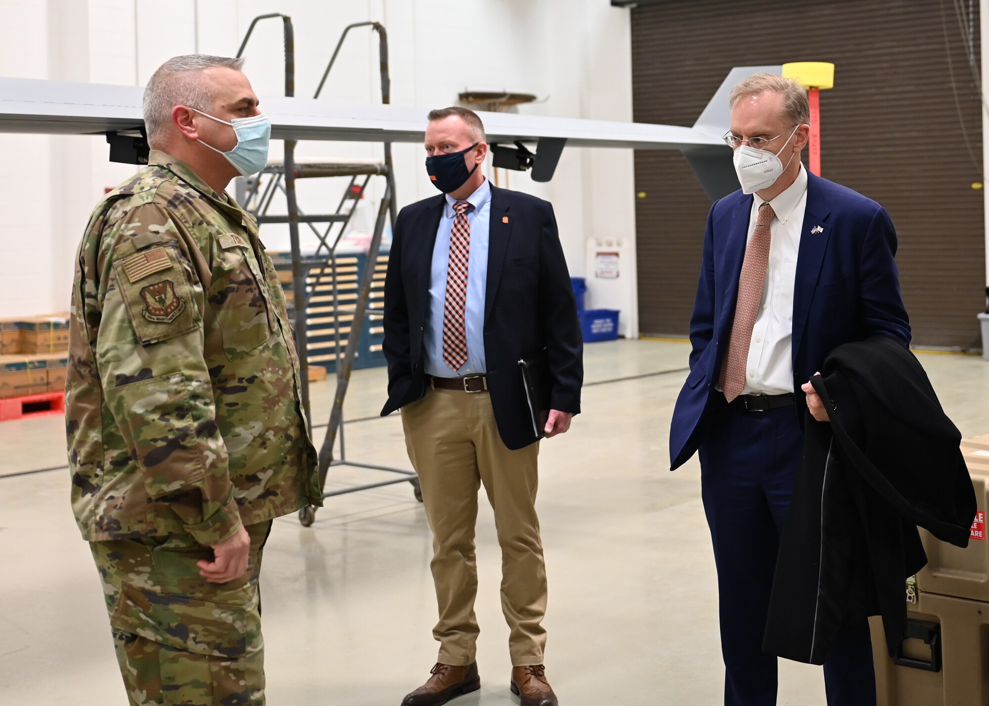 Syracuse University Chancellor Kent Syverud and Vice Chancellor for Strategic Initiatives and Innovation, Mike Haynie receive a tour from Senior Enlisted Leader, Chief Master Ian Tucker of the Field Training Detachment at Hancock Air National Guard base on Feb. 17, 2022.