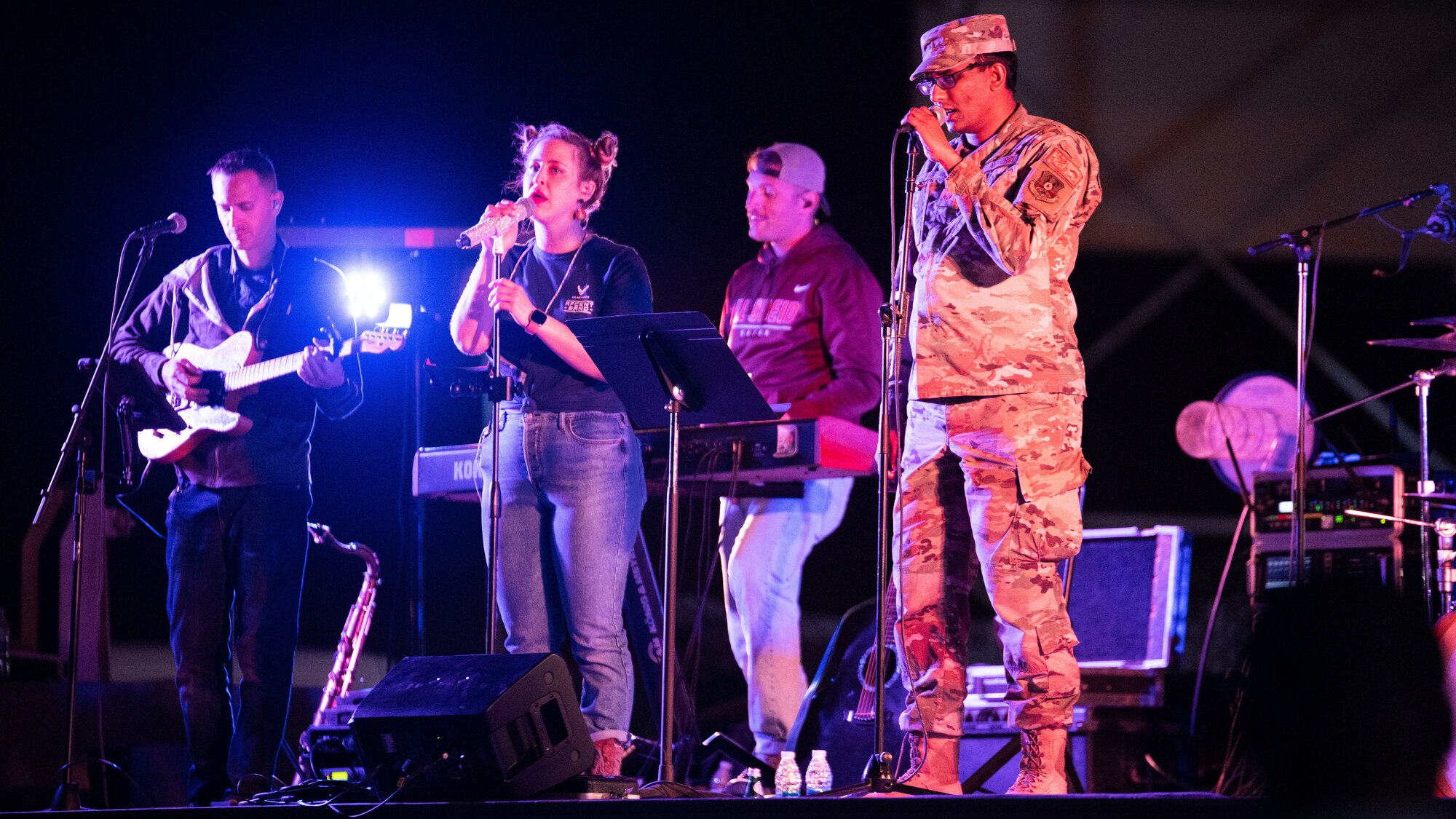 U.S. Air Force Senior Airman Ashish Naik, 378th Expeditionary Communication Squadron, client systems technician, performs alongside the U.S. Air Forces Central Band during a live band karaoke concert at Prince Sultan Air Base, Kingdom of Saudi Arabia, Feb. 27, 2022. The AFCENT Band is the only permanently assigned Air Force Band to the Central Command Area of Responsibility. (U.S. Air Force photo by Senior Airman Jacob B. Wrightsman)