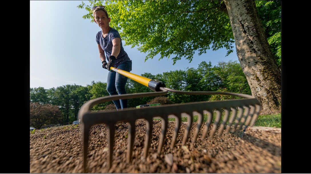 Jessa Farmer, a member of the Leadership Development Program, Level 2, for the U.S. Army Corps of Engineers Pittsburgh District helps clean up the East Branch Clarion River Lake clean up the campgrounds and visitor areas in Wilcox, Pennsylvania, May 26, 2021, for the dam's grand reopening. The ceremony celebrates the completion of the $250 million, East Branch Clarion River Dam Safety Modification project. The project began in 2014 and consisted of constructing a 2200 linear feet cutoff wall that penetrates up to 250 feet down through the middle of the earthen dam. (U.S. Army Corps of Engineers Pittsburgh District photo by Michel Sauret)