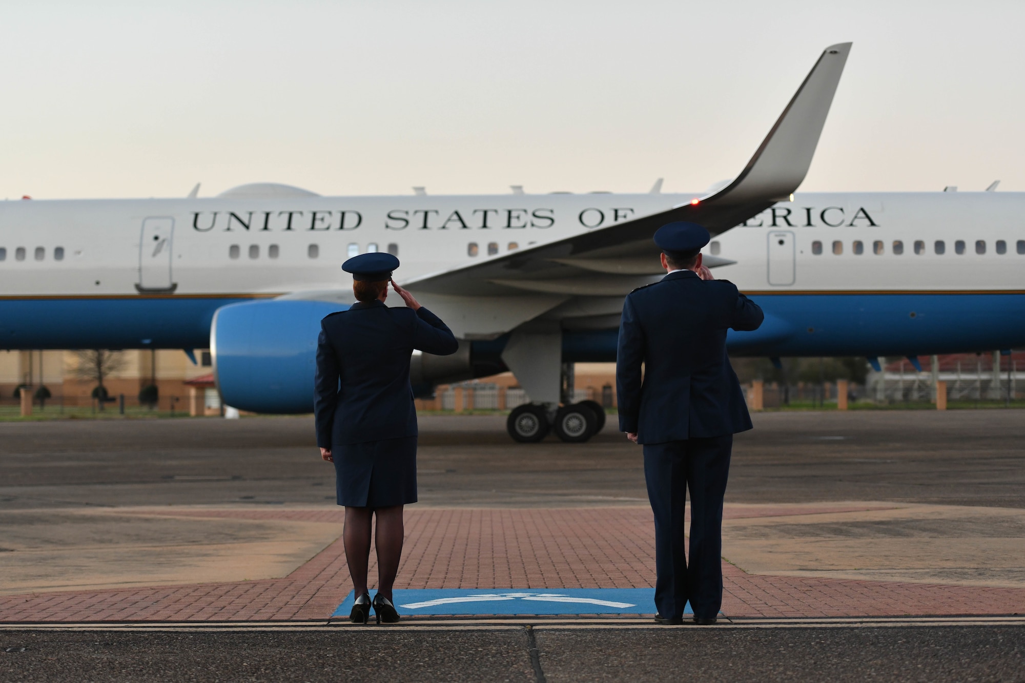 Col. Eries Mentzer, 42nd Air Base Wing commander, and Lt. Gen. James Hecker, Air University commander and president, salute Air Force Two as it departs from Maxwell Air Force Base, Alabama, March 6, 2022. Vice President Kamala Harris visited Alabama to commemorate the 57th anniversary of Bloody Sunday, a civil rights march that turned to tragedy. (U.S. Air Force photo by Senior Airman Jackson Manske)