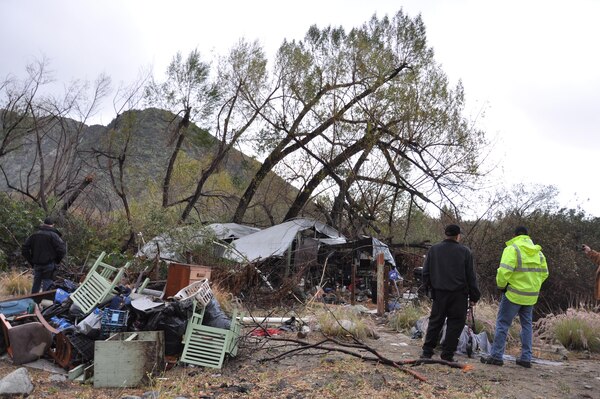 Officials survey an abandoned campsite before a 60-acre cleanup project by the U.S. Army Corps of Engineers Los Angeles District Feb. 22 near Azusa, California. The Corps’ LA District removed 128 tons of debris during the weeklong project. (Photo by John Reese, U.S. Army Corps of Engineers Los Angeles District)