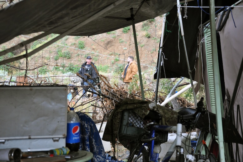 Trevor Snyder, project manager with the Operations and Maintenance Division, U.S. Army Corps of Engineers Los Angeles District, performs a walkthrough of abandoned campsites in the San Gabriel River with an Azusa Police Department officer Feb. 22 near Azusa, California. The Azusa Police Department and the Corps’ LA District worked in partnership to safely complete the riverbed cleanup project. (Photo by John Reese, U.S. Army Corps of Engineers Los Angeles District)