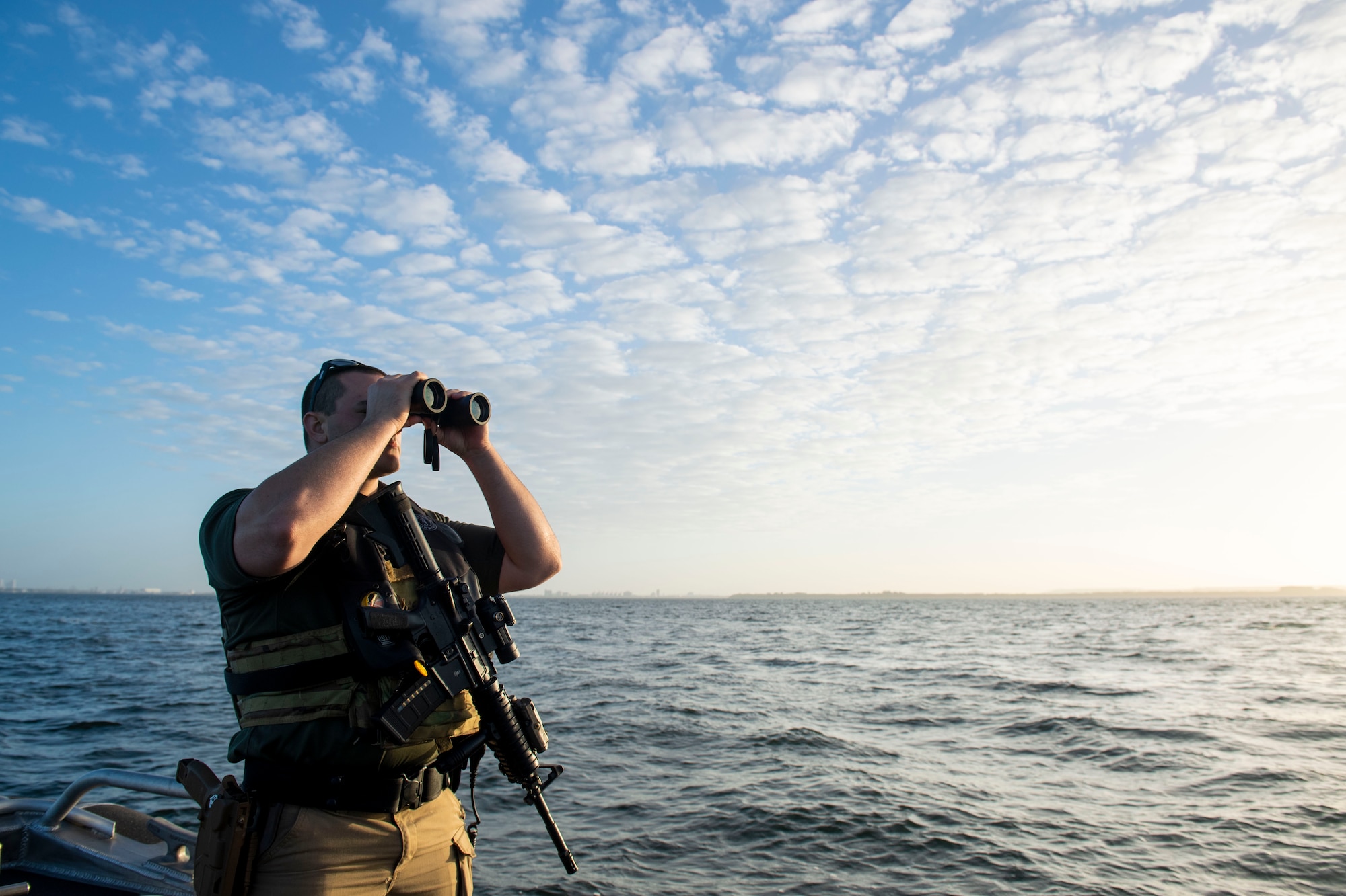 U.S. Air Force Airman 1st Class Jake Baker, 6th Security Forces Squadron marine patrolman, scans the waters surrounding MacDill Air Force Base, Florida, March 7, 2022.