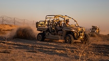 Two marines drive a Utility Task Vehicle (UTV)