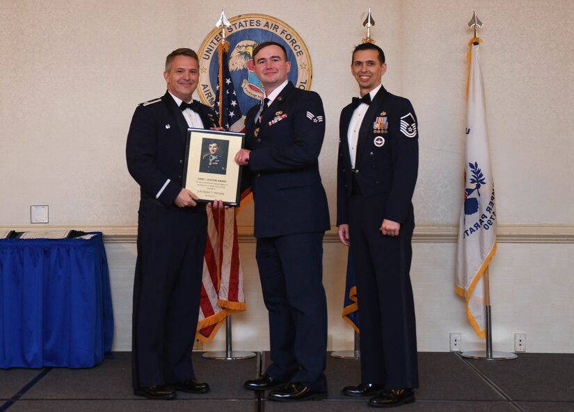 U.S. Air Force Senior Airman Dylan Hensley, 437th Maintenance Squadron, accepts the John L. Levitow Award during the graduation of Airman Leadership School Class 22-C, at Joint Base Charleston, South Carolina, Mar. 3, 2022. The Levitow Award is presented to the student demonstrating the highest level of leadership and scholastic performance, and is partially determined by their peers.