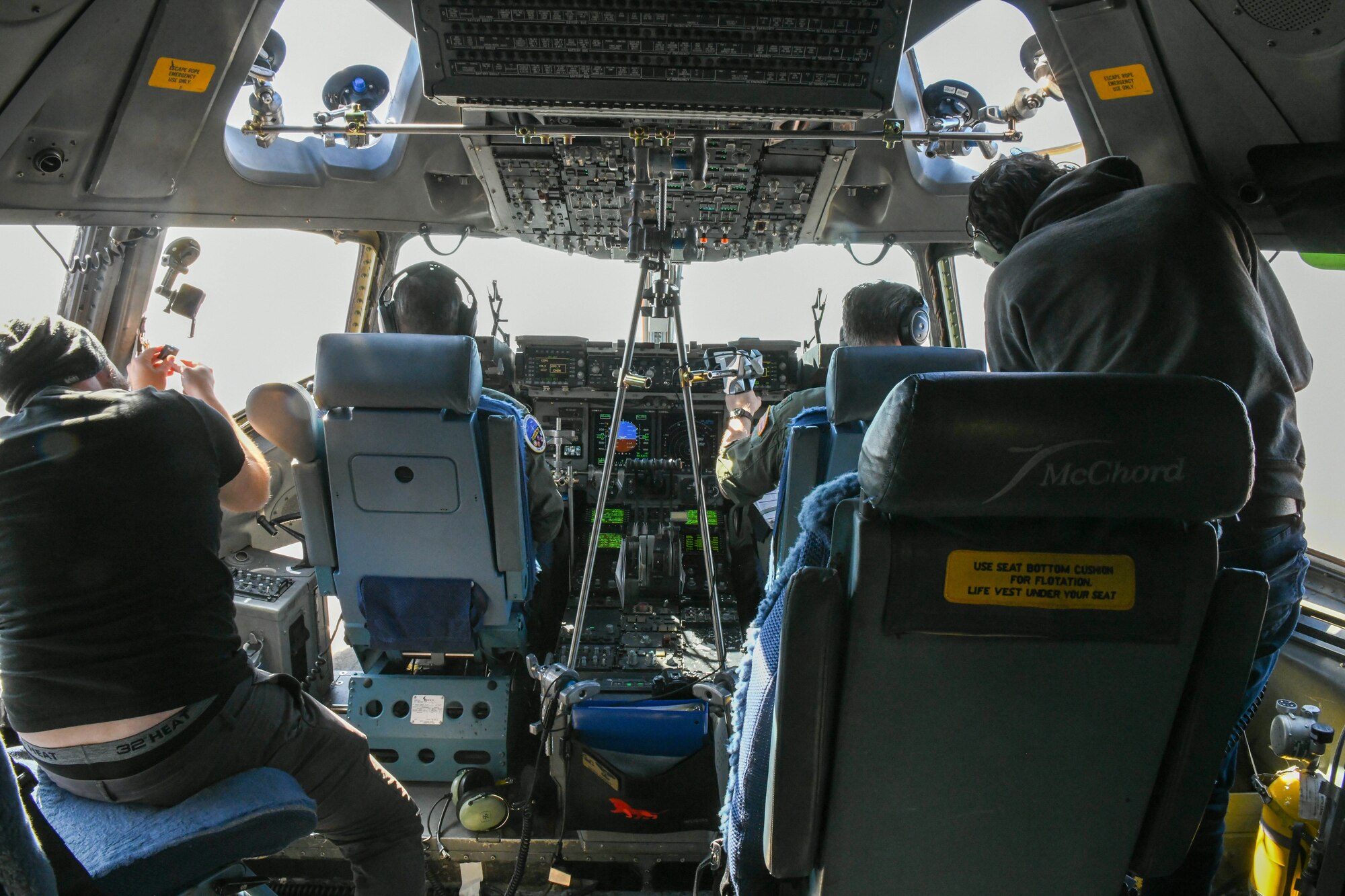 Members of Specular Theory adjust their scanning instruments in the cockpit of a C-17 Globemaster III at Altus Air Force Base, Oklahoma, Feb. 11, 2022. With the help of companies like Specular Theory, the 97th Operations Group has brought in new simulators and lesson tools for their students to use. (U.S. Air Force photo by Airman 1st Class Trenton Jancze)