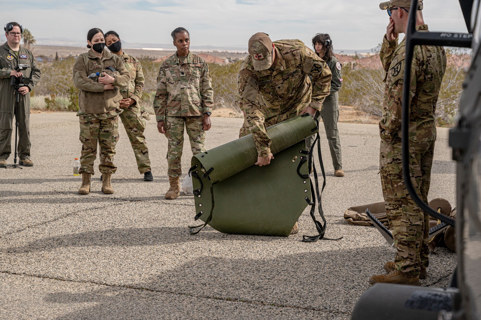 Flight paramedic Spc. Joshua Hronowski, Charlie Company, 2916th Aviation Battalion, 916th Support Brigade, conducts medevac training with Airmen from the 412th Medical Group at Edwards Air Force Base, California, March 3.  (Air Force photo by Katherine Franco)