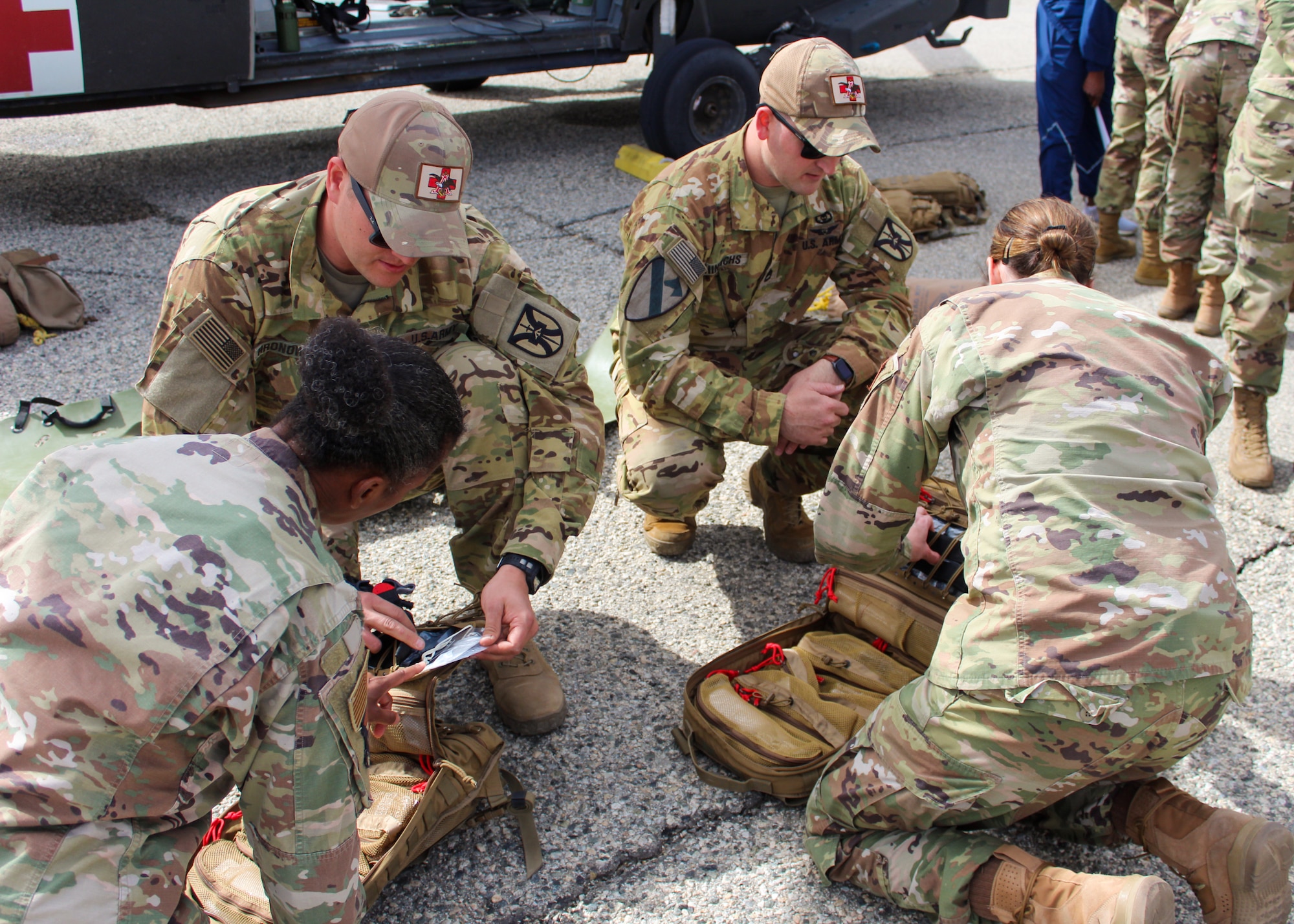 Flight paramedics Spc. Joshua Hronowski and Sgt. 1st Class Jason Hinrichs, both from Charlie Company, 2916th Aviation Battalion, 916th Support Brigade, conduct medevac training with Airmen from the 412th Medical Group at Edwards Air Force Base, California, March 3. (Air Force photo by Laura Maples)