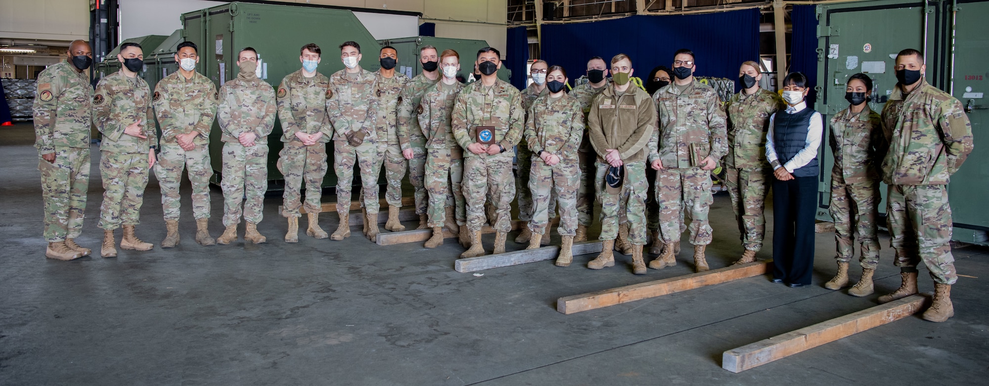 Military members stand together to commemorate an award.