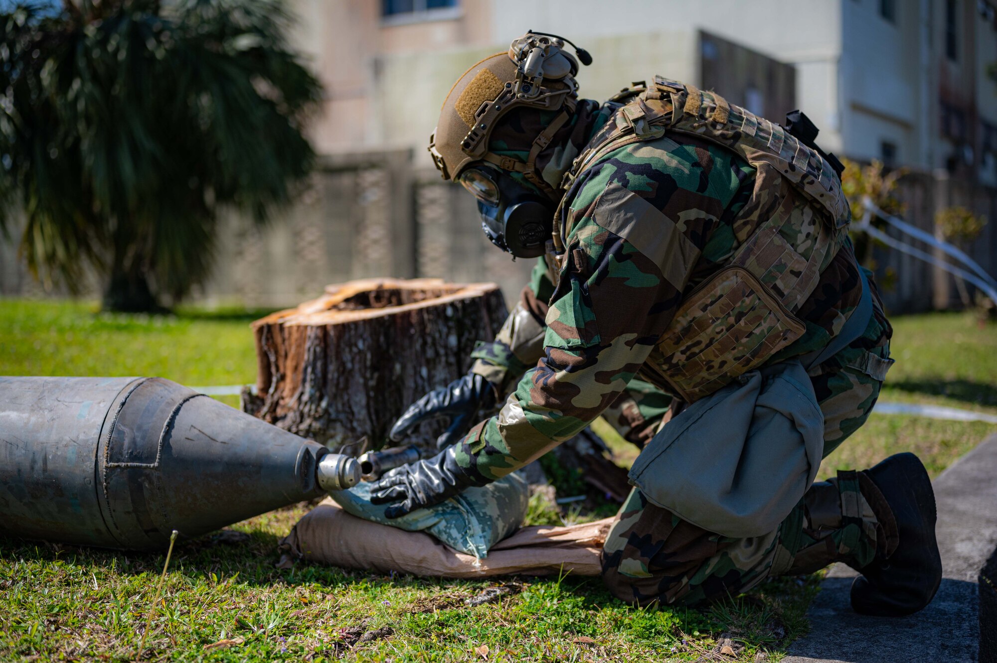 Airman looks at bomb.