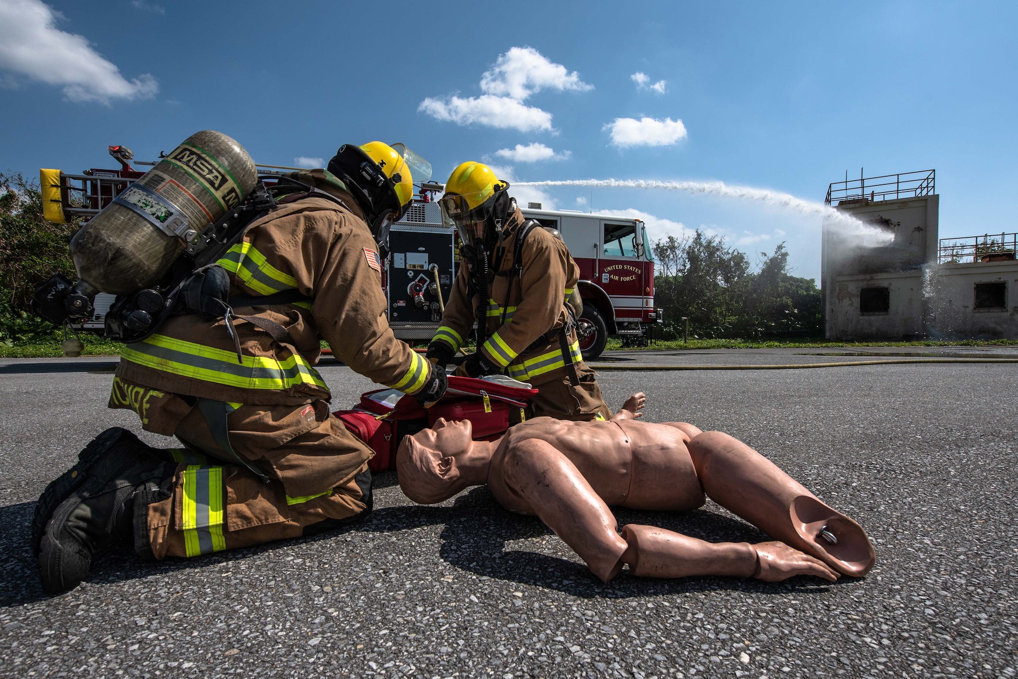 Firefighters help a fake patient.