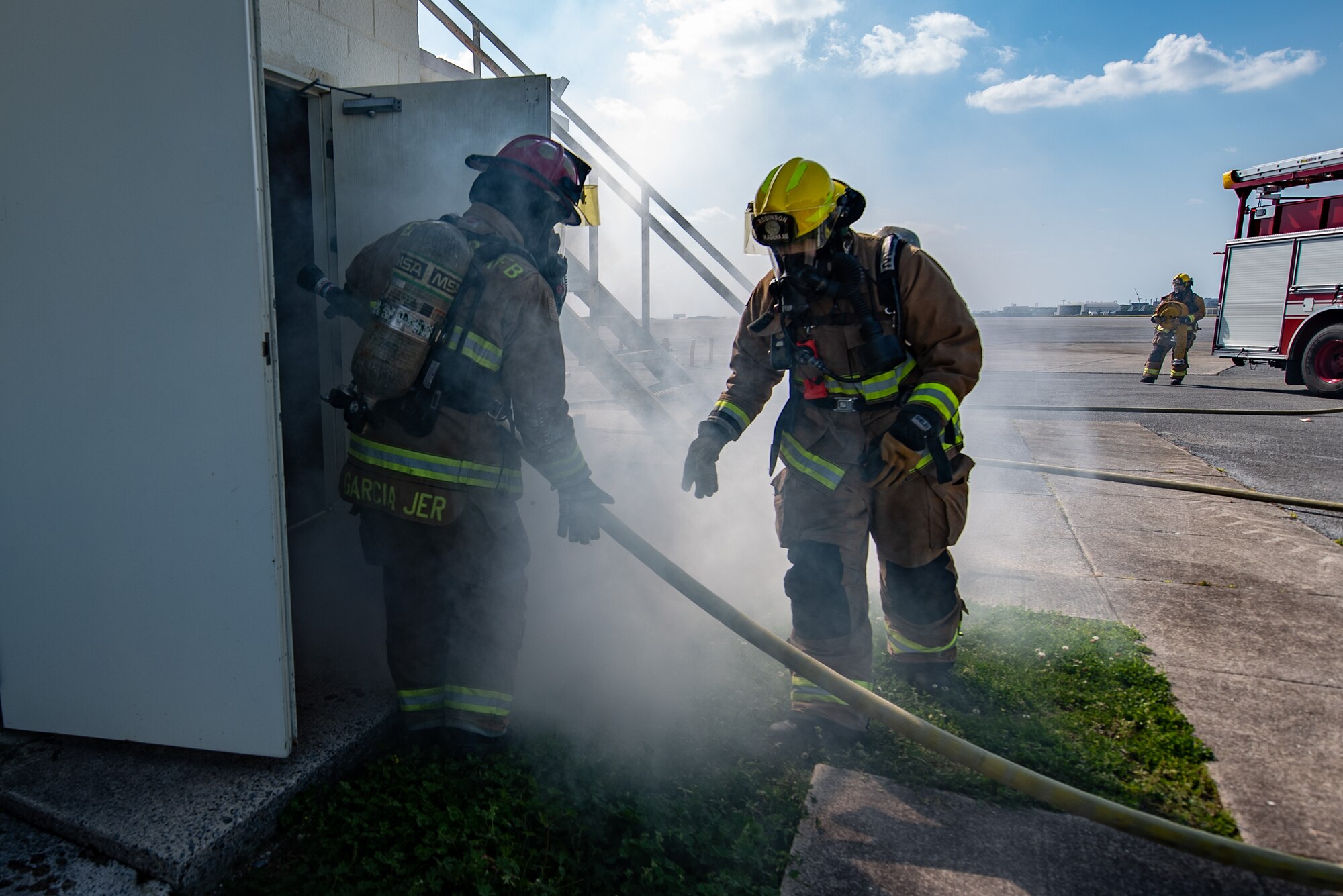 Firefighters enter building.