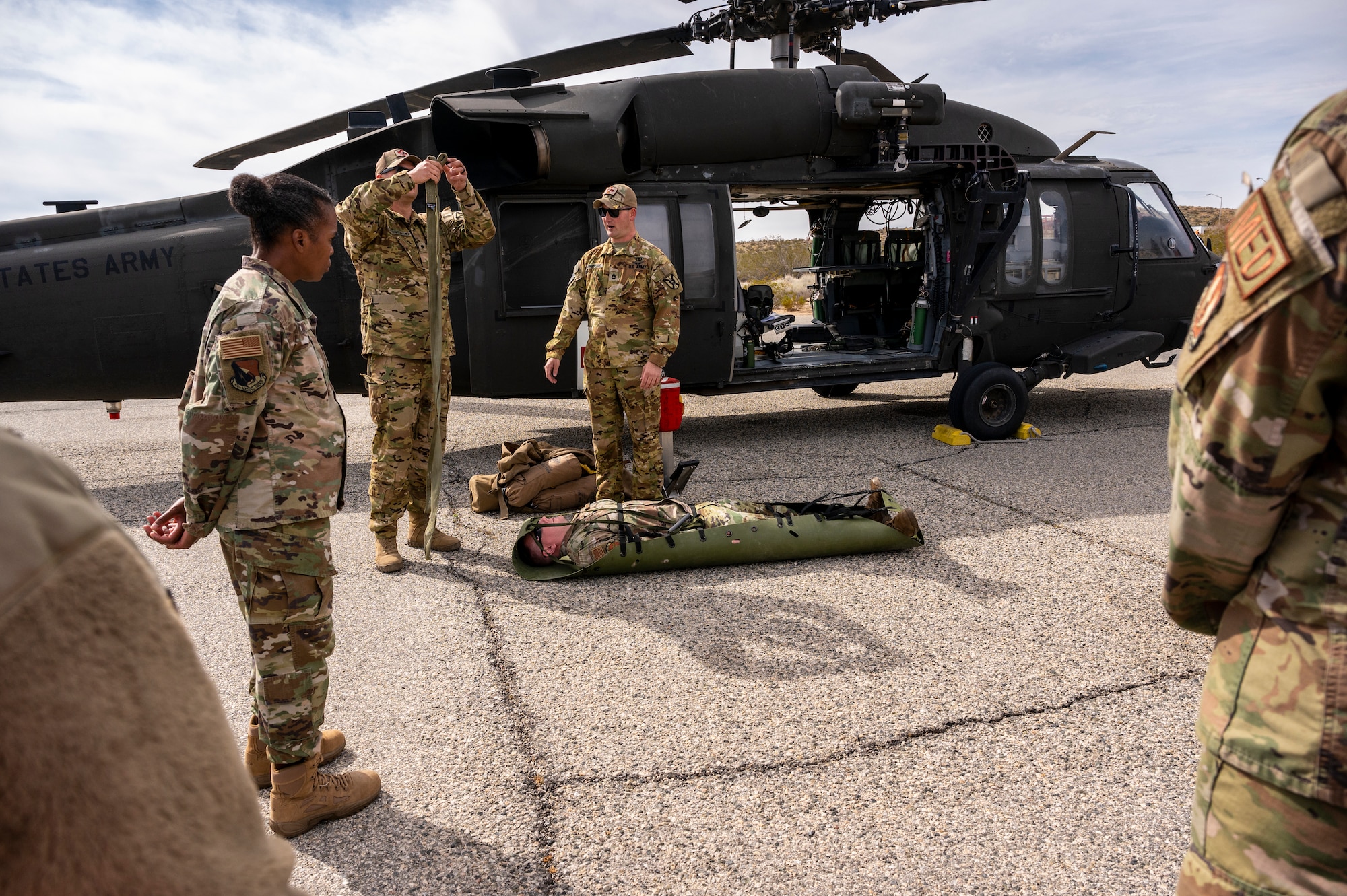 Soldiers from C Comapny, 2916th Aviation Battalion, 916th Support Brigade and Airmen from the 412th Medical Group, conduct medevac training at Edwards Air Force Base, California, March 3. (Air Force photo by Katherine Franco)