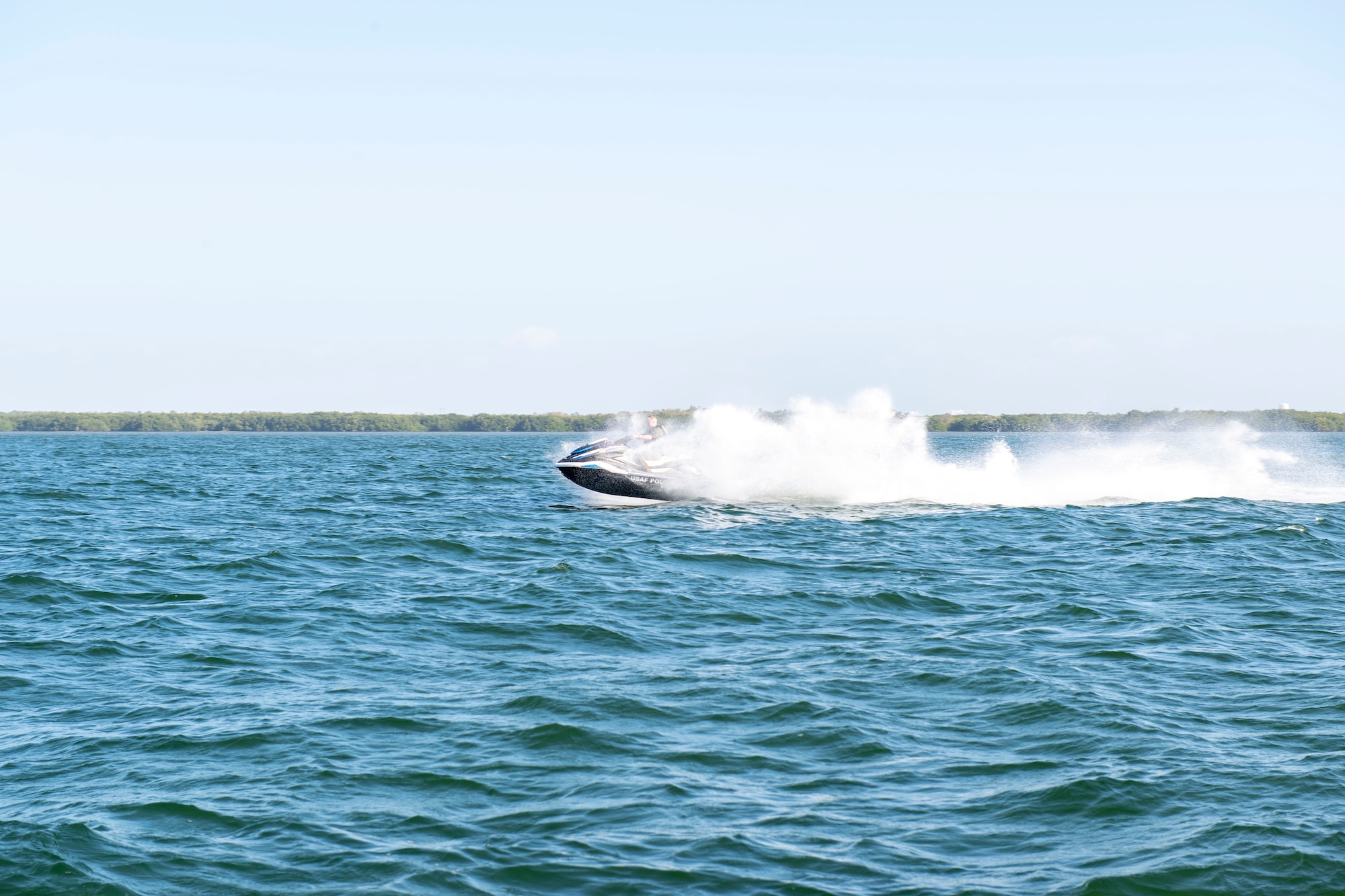 U.S. Air Force Senior Airman Garrett Stevens, 6th Security Forces Squadron marine patrolman, performs high-speed maneuvers in Tampa Bay, Florida, March 7, 2022.