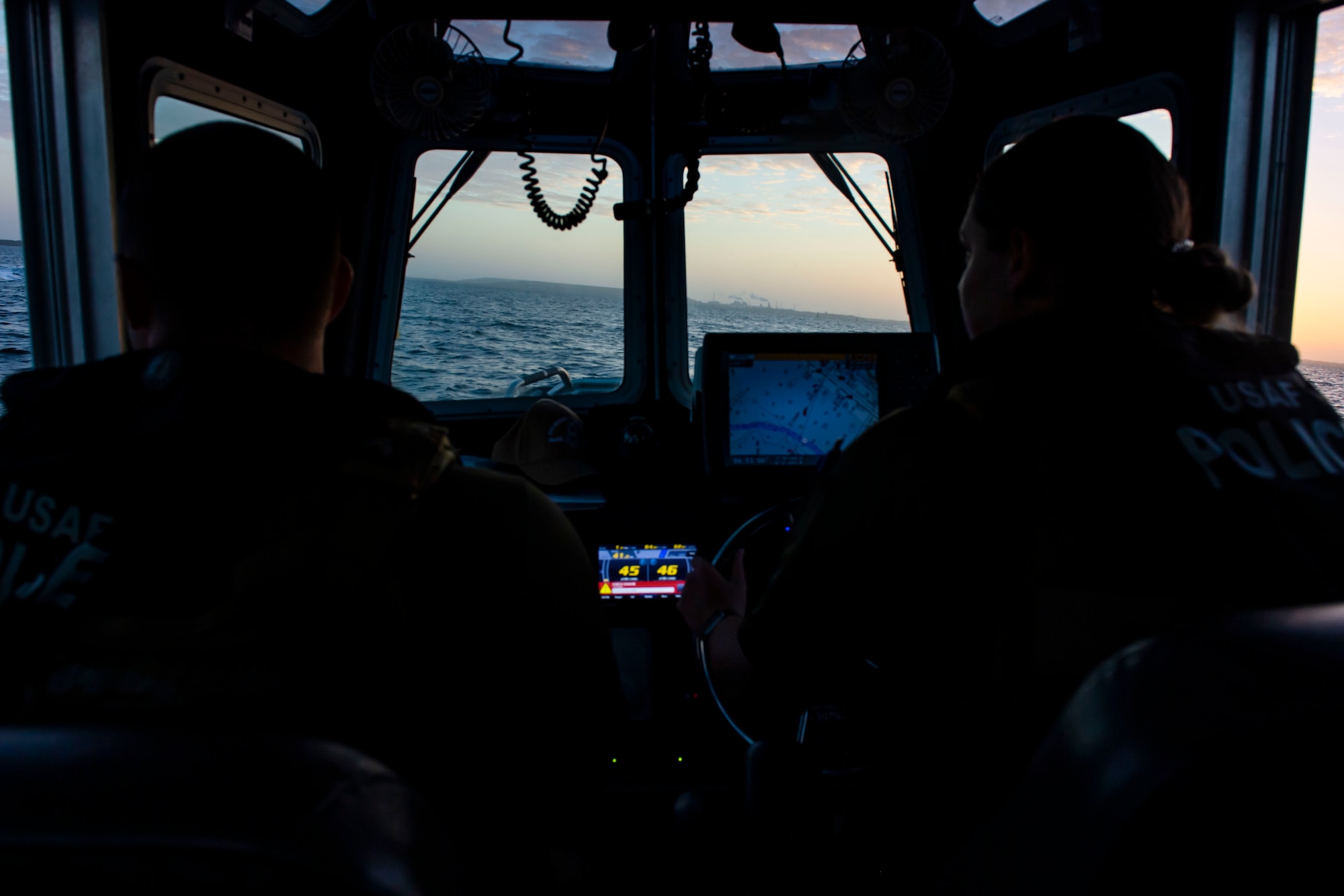 Marine patrolmen assigned to the 6th Security Forces Squadron scan the waters surrounding MacDill Air Force Base, Florida, March 7, 2022.