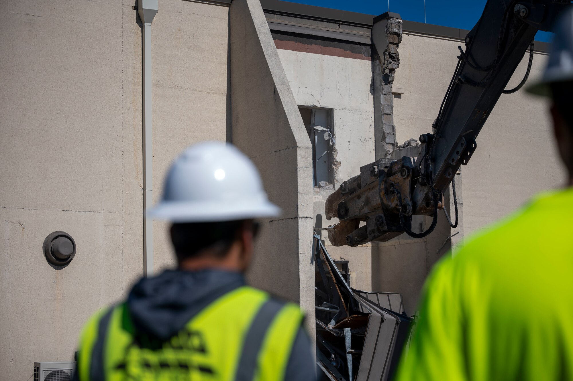a building is demolished with excavator