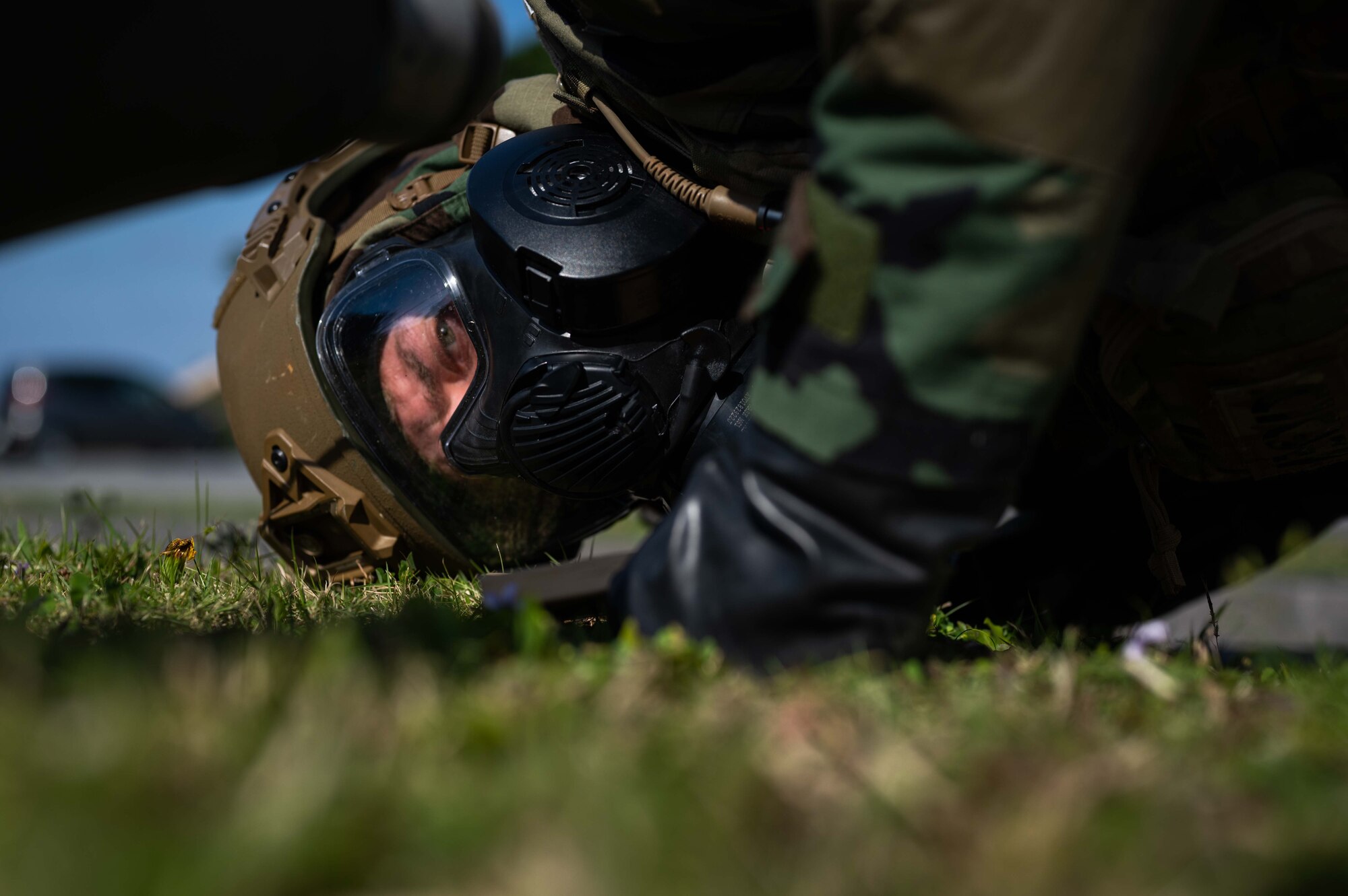 Airman looks under bomb.