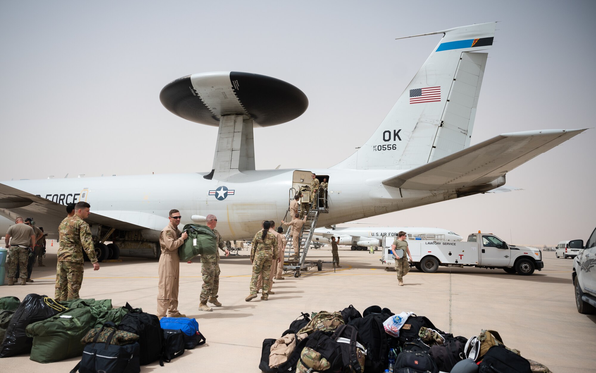 U.S. Air Force Airmen from the 968th Expeditionary Airborne Air Control Squadron unload bags from an E-3 Sentry at Prince Sultan Air Base, Kingdom of Saudi Arabia, March 6, 2022. The 968th EAACS provides airborne, command and control, all-weather surveillance and communications to the U.S. and its coalition partners. (U.S. Air Force photo by Senior Airman Jacob B. Wrightsman)