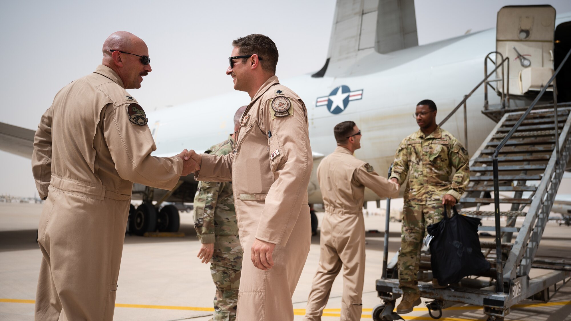U.S. Air Force Col. Kevin Davidson, 378th Air Expeditionary Wing vice commander, greets U.S. Air Force Lt. Col. Steven Bailey, 968th Expeditionary Airborne Air Control Squadron commander, at Prince Sultan Air Base, Kingdom of Saudi Arabia, March 6, 2022. Previously stationed at Al Dhafra Air Base, United Arab Emirates, the 968th EAACS will now begin operating from PSAB. (U.S. Air Force photo by Senior Airman Jacob B. Wrightsman)