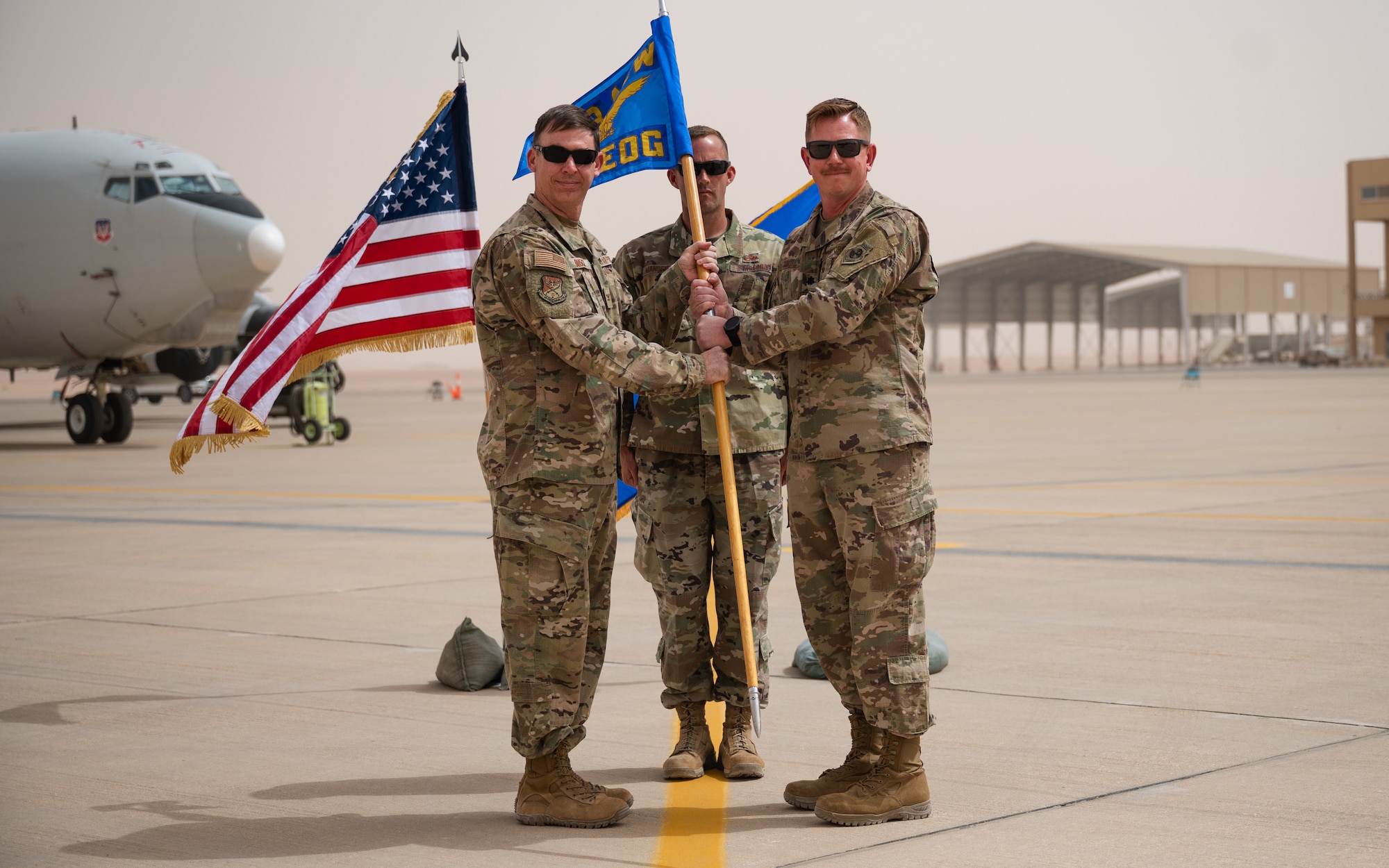 U.S. Air Force Lt. Col. Jason Purcell, right, incoming 378th Expeditionary Aircraft Maintenance Squadron commander, receives the guidon from U.S. Air Force Col. Benjamin Busch, left, 378th Expeditionary Operations Group commander, during the 378th EAMXS unit activation ceremony at Prince Sultan Air Base, Kingdom of Saudi Arabia. The passing of a squadron's guidon symbolizes the transfer of command. (U.S. Air Force photo by Senior Airman Jacob B. Wrightsman)