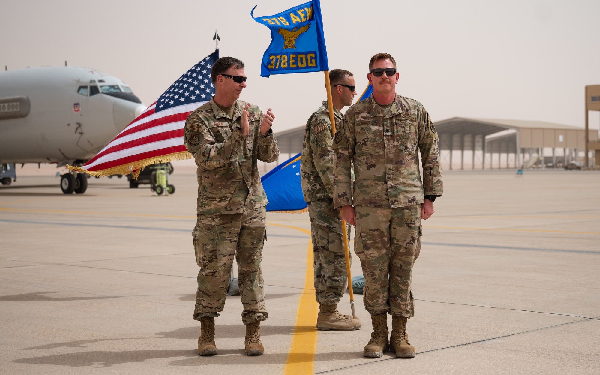 U.S. Air Force Col. Benjamin Busch, 378th Expeditionary Operations Group commander, congratulates U.S. Air Force Lt. Col. Jason Purcell, incoming 378th Expeditionary Aircraft Maintenance Squadron commander, during the 378th AMXS unit activation ceremony at Prince Sultan Air Base, Kingdom of Saudi Arabia, March 7, 2022. The 378th EAMXS is tasked with maintaining the combat readiness of PSAB’s KC-10 Extenders and E-3 Sentries. (U.S. Air Force photo by Senior Airman Jacob B. Wrightsman)