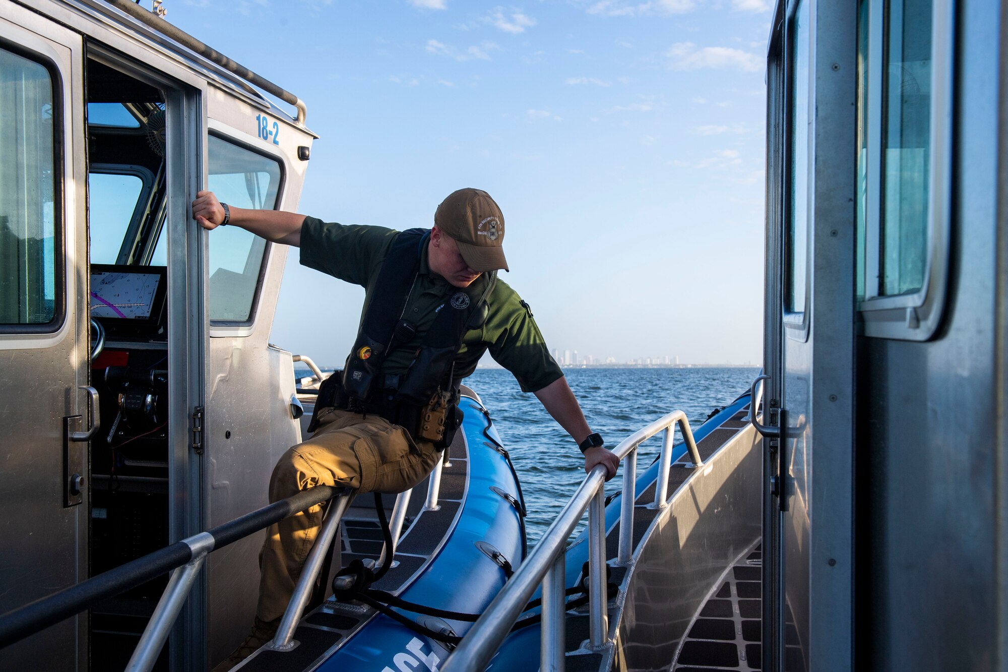 U.S. Air Force Senior Airman Garrett Stevens, 6th Security Forces Squadron marine patrolman, ties two boats together in Tampa Bay, Florida, March 7, 2022.