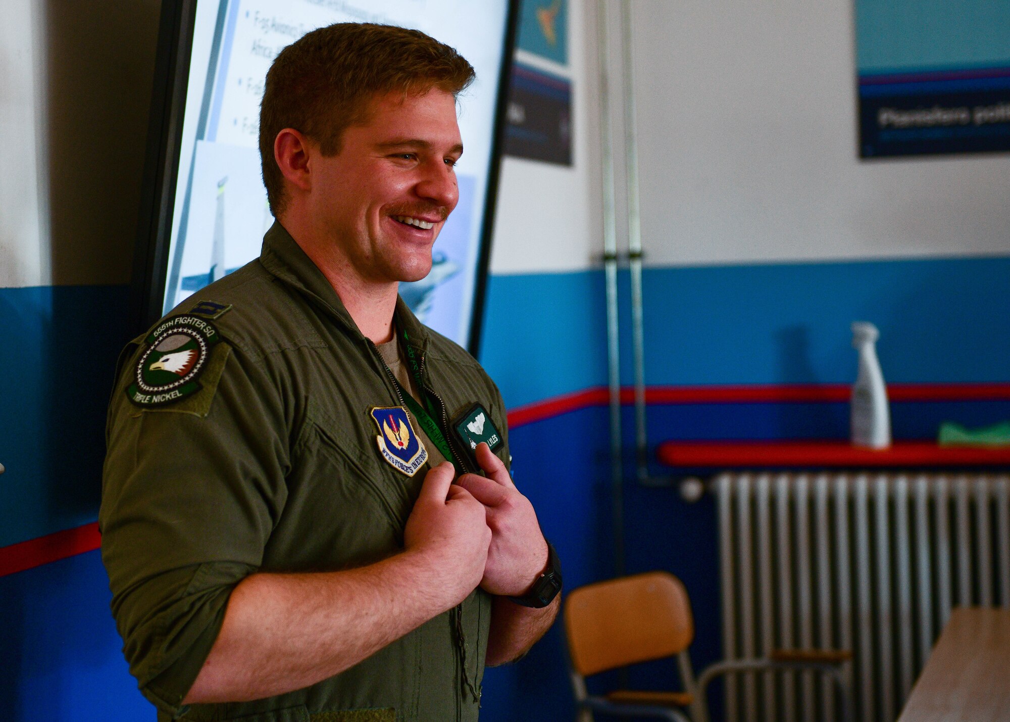 U.S. Air Force Capt. Guice Lyles, 555th Fighter Squadron F-16 Fighting Falcon pilot, speaks to a group of aeronautical high school students during a visit at the Nobile Aviation college in Udine, Italy, March 8, 2022. A pilot and maintainer from the 31st Fighter Wing and the Italian air force Air Traffic Control Tower commander spoke in front of approximately 60 aeronautical high school students and shared their experiences of being in the military. (U.S. Air Force photo by Senior Airman Brooke Moeder)