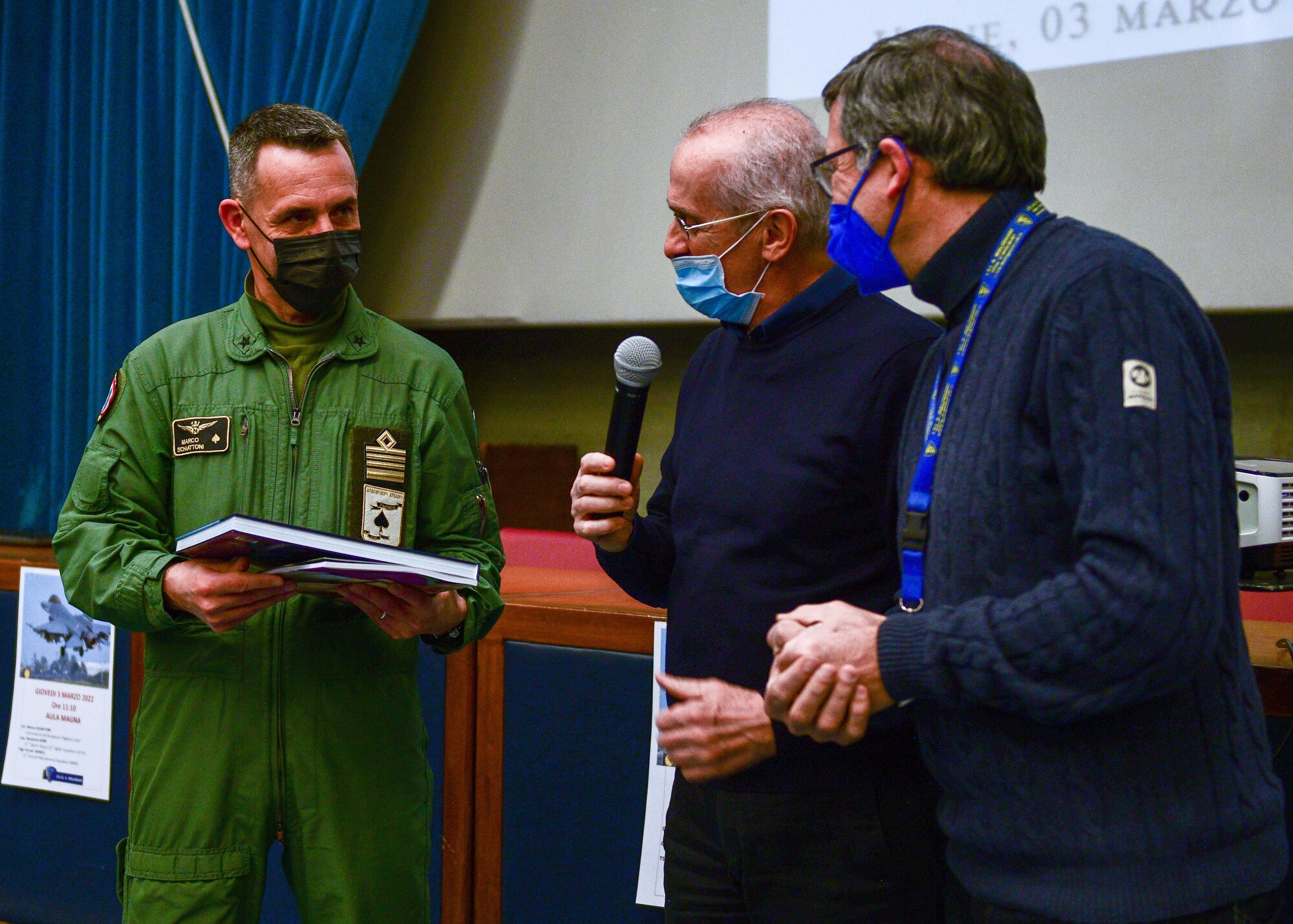 Italian air force Col. Marco Schiattoni, ‘Pagliano e Gori’ Airport commander, receives a gift from the Malignani Aeronautical Institute principal in Udine, Italy, March 3, 2022. The school is considered one of the biggest Italian technical high schools in terms of the number of students. (U.S. Air Force photo by Senior Airman Brooke Moeder)