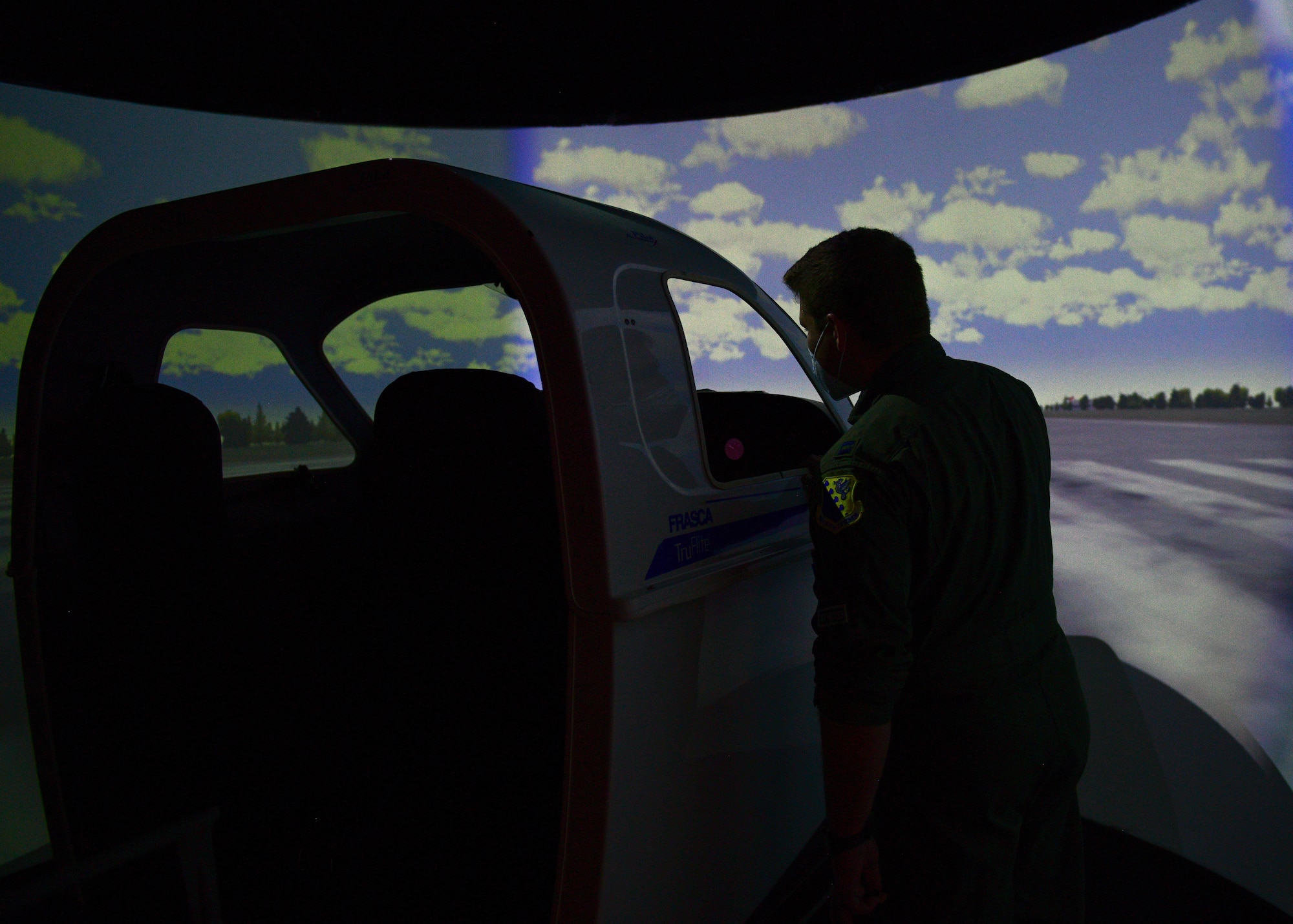 U.S. Air Force Capt. Guice Lyles, 555th Fighter Squadron F-16 Fighting Falcon pilot, looks at a flight simulator at the Nobile Aviation college in Udine, Italy, March 8, 2022. Lyles and an F-16 maintainer, and the Italian air force Air Traffic Control Tower (ATC) commander visited aeronautical high school students and shared their experiences from their jobs, highlighting challenges and accomplishments of each job. (U.S. Air Force photo by Senior Airman Brooke Moeder)